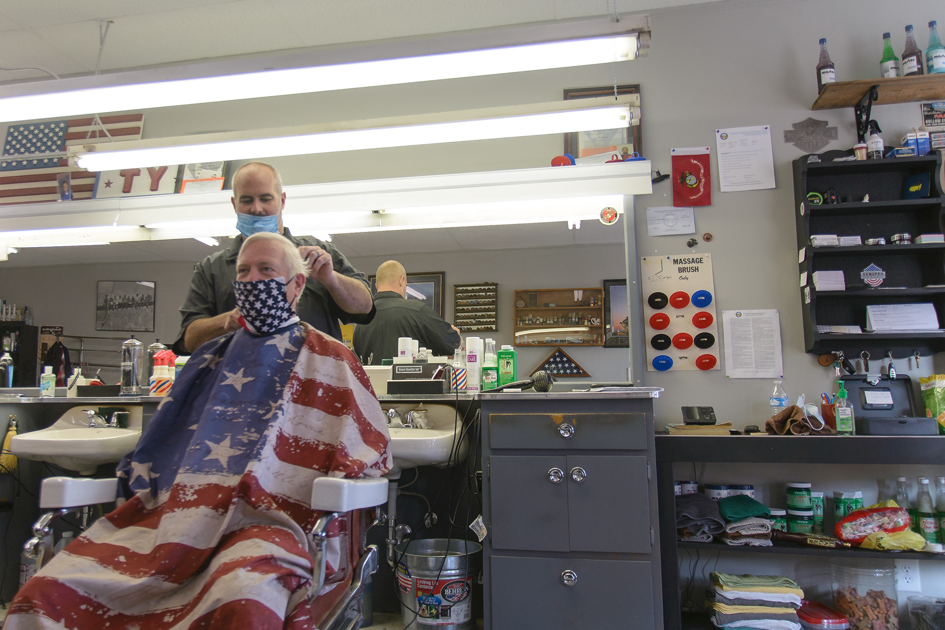 Barber Colin Pack begins cutting Bill Pursel's hair on May 15, 2020. The Vine Street Barbershop in Mount Vernon began taking customers as personal services were reopened after the COVID-19 pandemic closed barbershops and hair salons for two months.