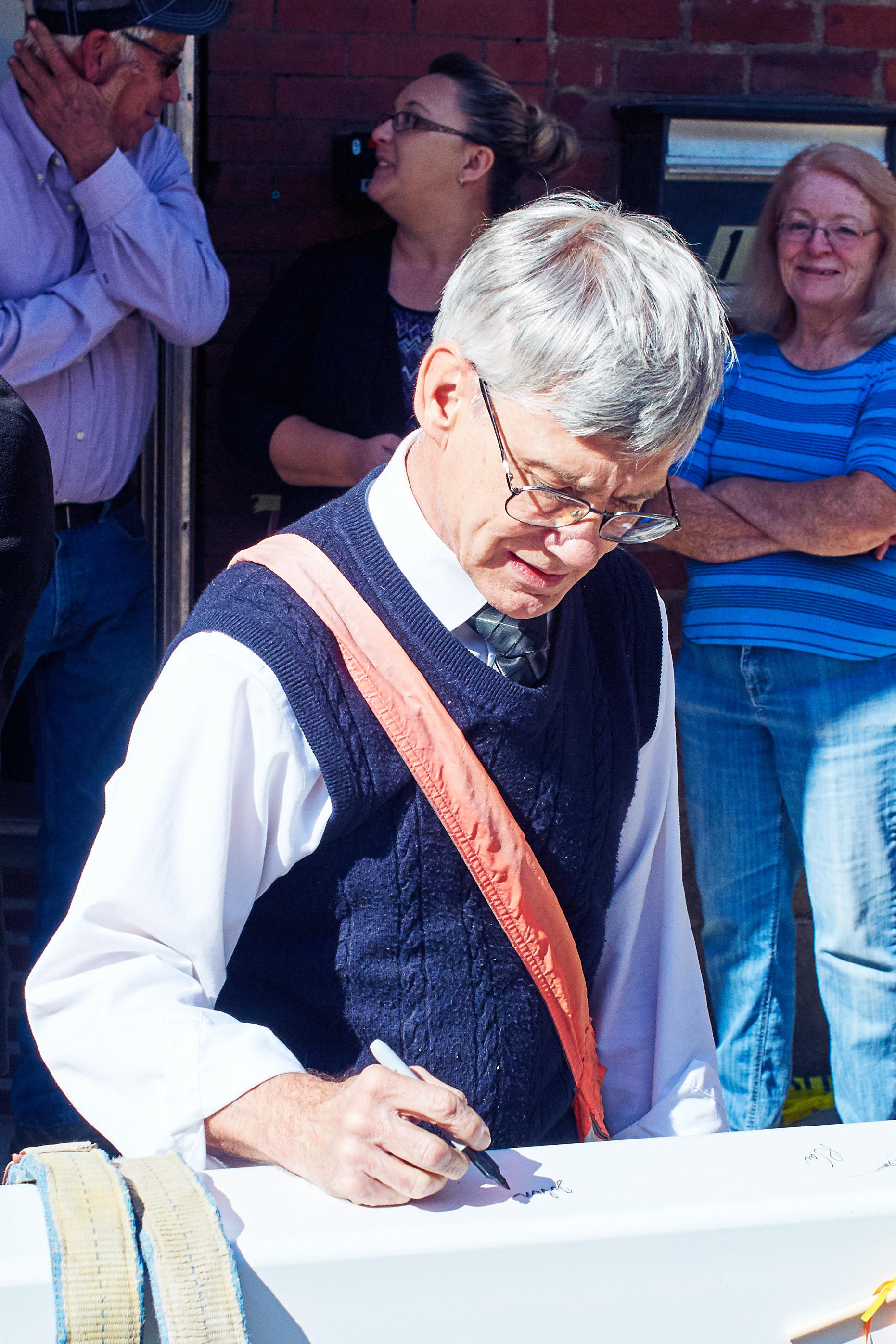 Circulation Department's John Nixon signs a beam of the Woodward Opera House as he delivers newspapers in the downtown area of Mount Vernon.