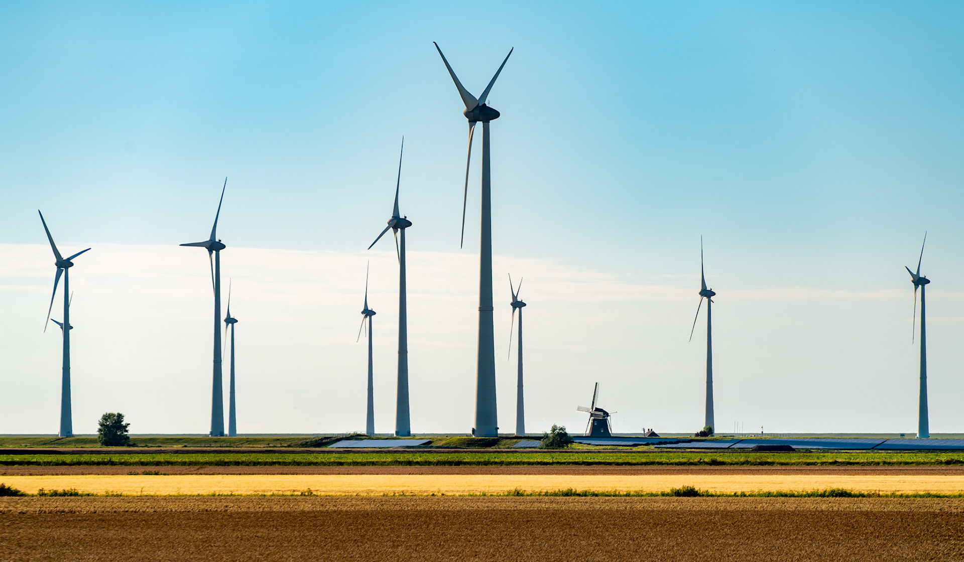 In the past, windmills were used to grind grains or to pump water. Nowadays, the innovate turbines generate clean electricity, in this case in combination with solar panels hidden in the Dutch landscape.