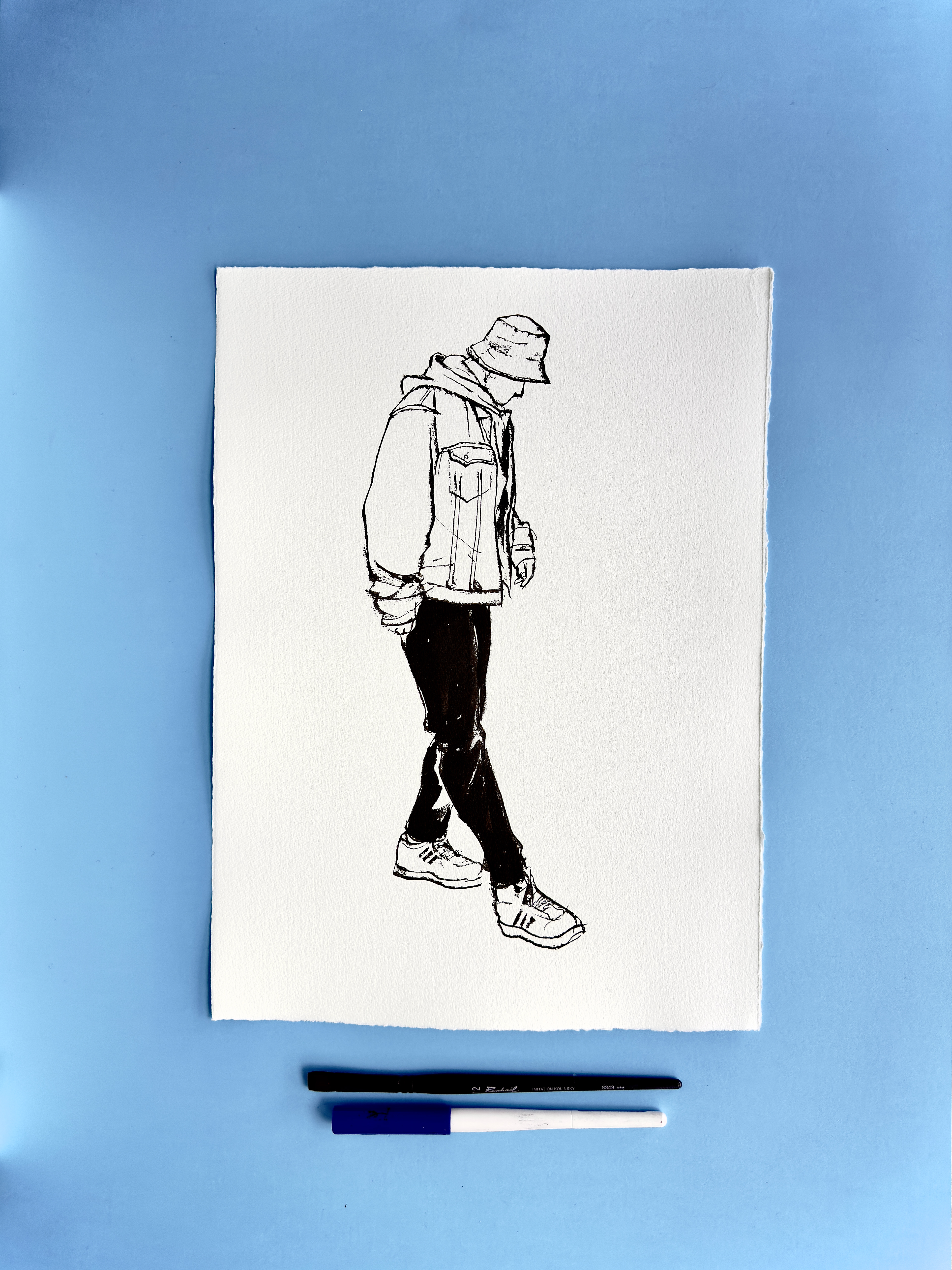 I DRAW YOU is an ongoing series of contemporary figure drawings exploring everyday bodies, fashion, and movement through expressive ink linework on textured cotton paper. Each piece captures real people in natural, unposed moments—walking, skating, taking selfies, or simply inhabiting their clothes—transforming daily gestures into minimal, dynamic portraiture.  Drawn with a combination of brush, parallel pen, and ink, the series focuses on gesture, proportion, and character, emphasising rhythm and immediacy over facial detail. Instead of traditional portrait likeness, the drawings celebrate silhouette, attitude, and personal style, making each figure both intimate and universal.  These original artworks sit at the crossroads of illustration, fashion drawing, and figurative art, making them ideal for collectors interested in line art, contemporary drawing, and minimal ink portraits. Every piece is hand-drawn on archival 250–300g paper, preserving the texture and spontaneity of the process.  Perfect for art lovers looking for unique figure drawings, modern ink artwork, or original works on paper that highlight the beauty of everyday bodies and the immediacy of the drawn line.