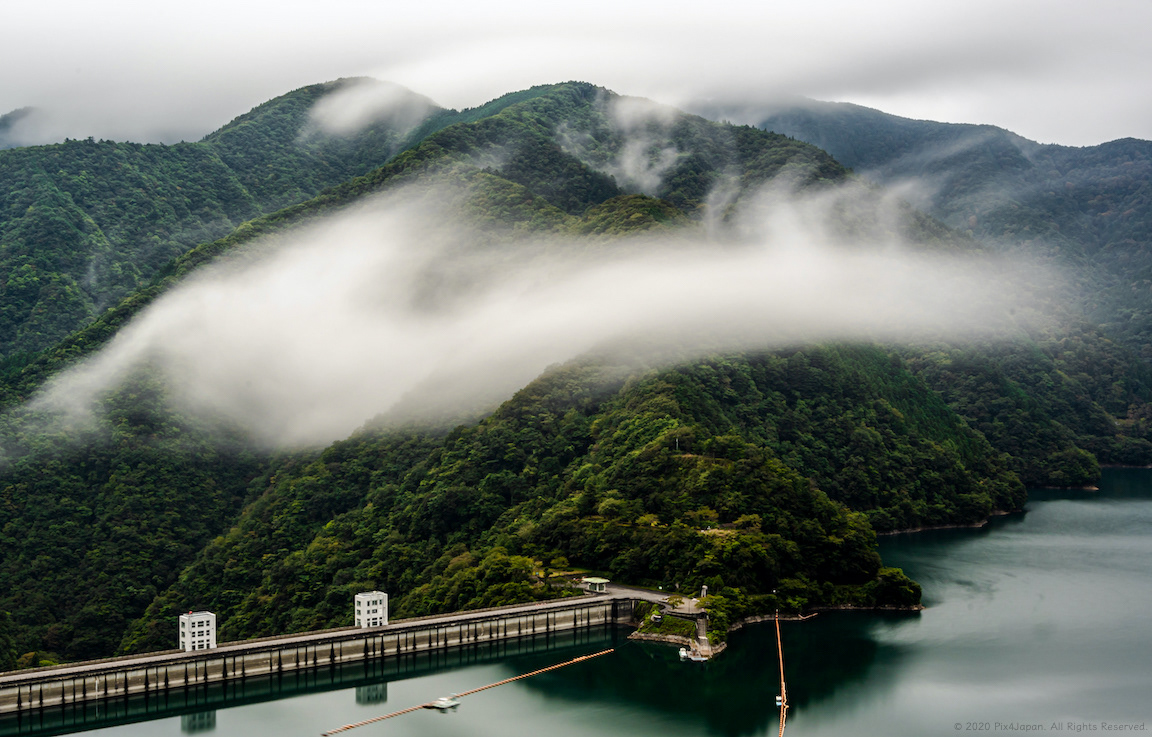Mist over Forest near Dam in Japanese Mountains