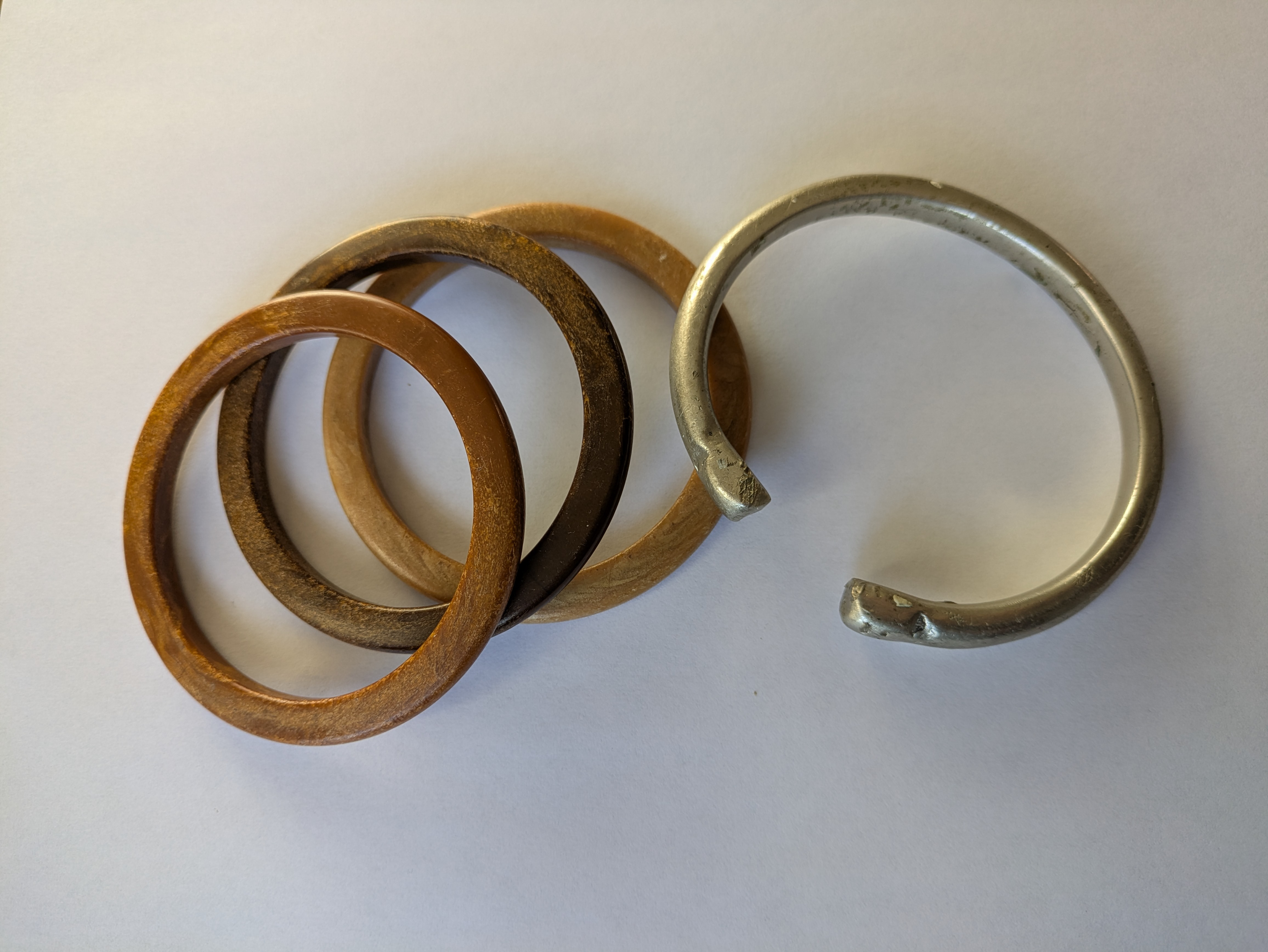 Fae’s object: “The silver bracelet was my dad’s. He took it off a few years ago and gave it to me. All of my memories of him are with this bracelet that he got in India, and he had it hammered onto his arm. That is like a part of him that I can have, and I can keep. My mum lost her mum at a young age and gave me those [wooden] bracelets. I have a picture of my grandmother wearing them that I’ve got on my wall. I wear those brown bracelets when I want to feel connected, or when I’m doing something special I’ll put them on. [The silver and wooden bracelets] together are my connection to my heritage, in a way.” Credit: Fae Wolfe
