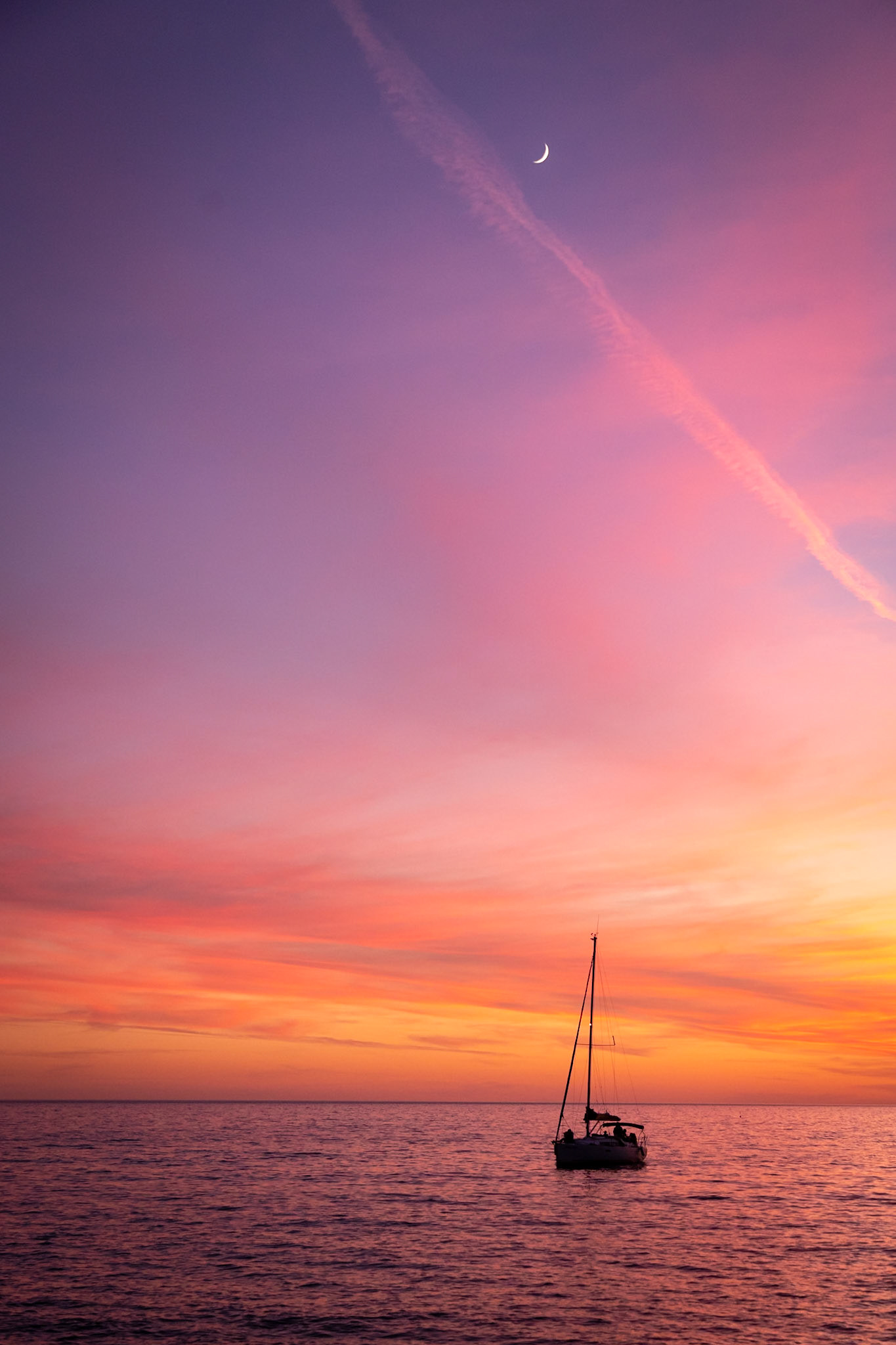 Sailboat at Sunset: Returning to Port Ginesta Marina at dusk