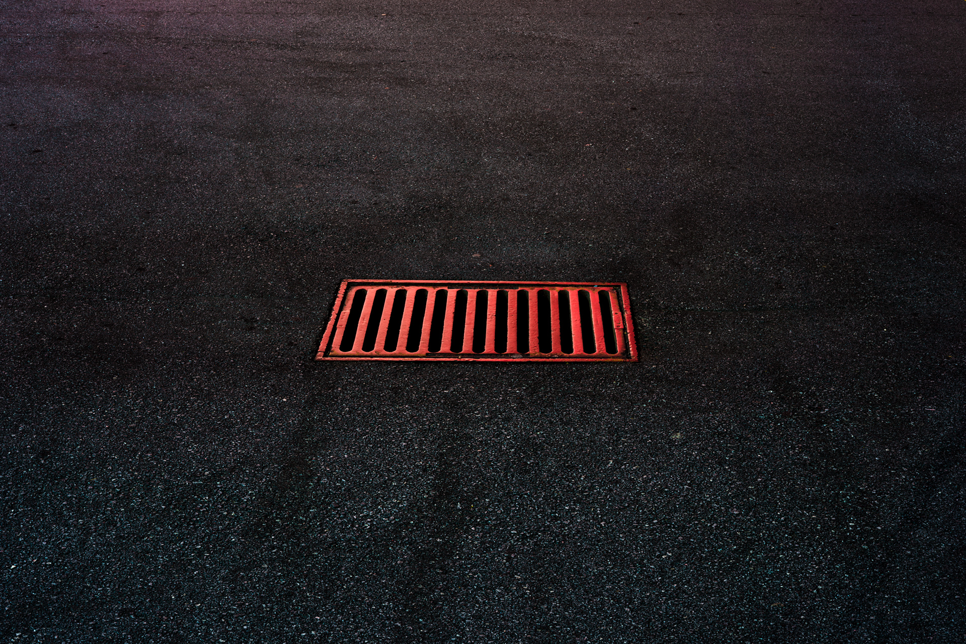 Sewer grate under artificial light, Atlanta Georgia
