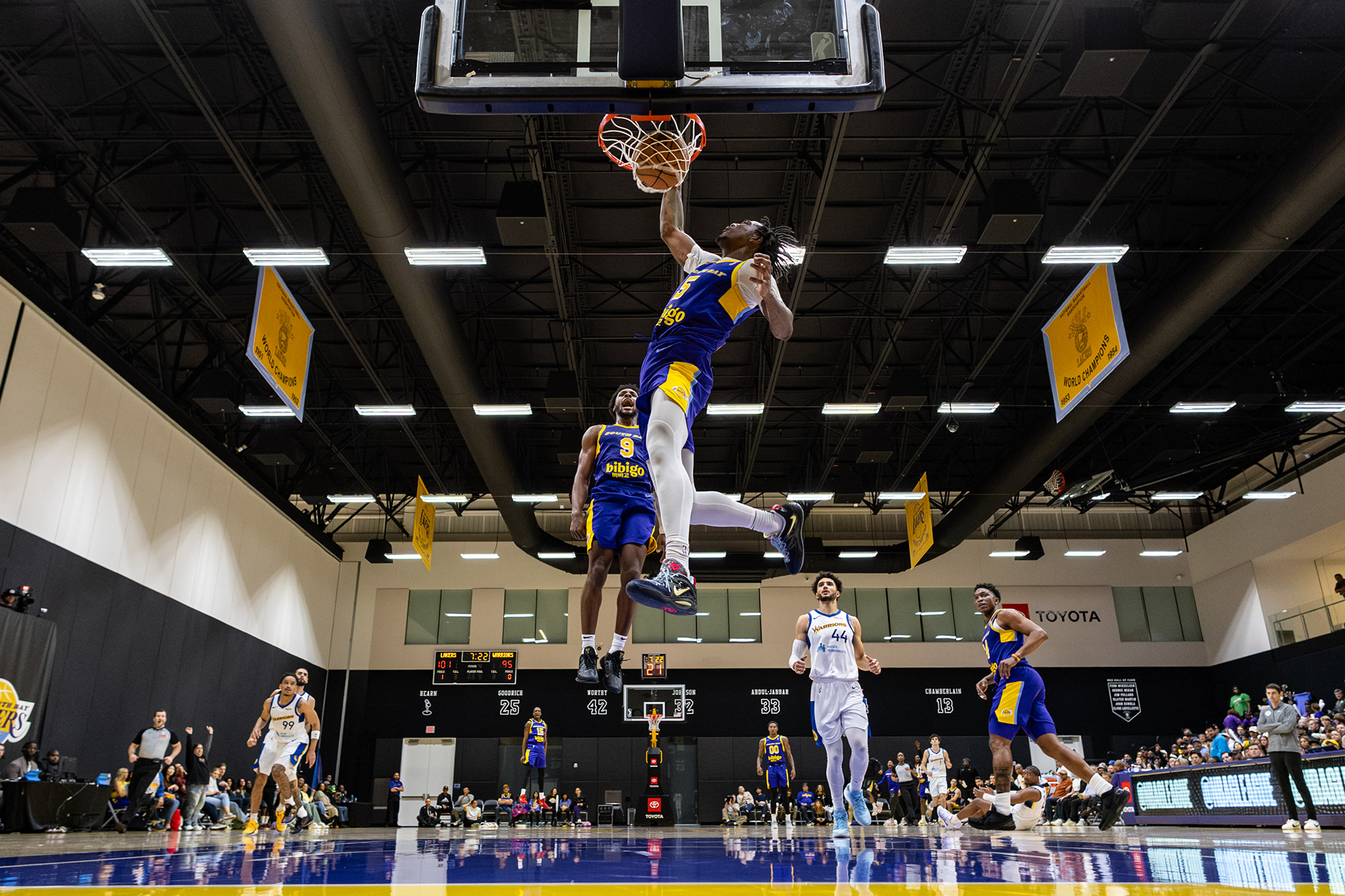 South Bay Lakers guard Bronny James jumps as forward Joirdon Nicholas dunks the ball in an NBA G-League game at UCLA Health Training Center in El Segundo, CA