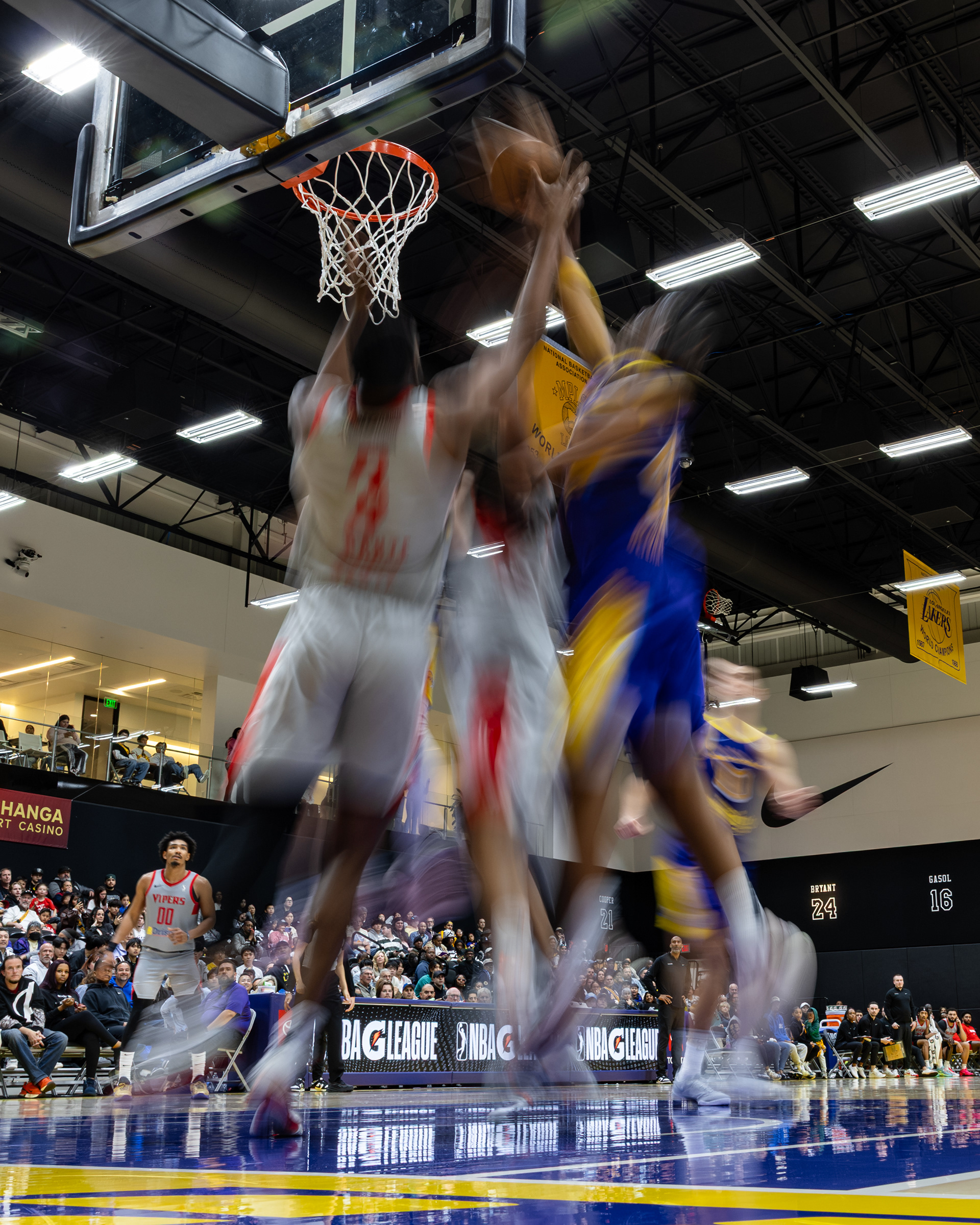 NBA G-League players reach for the basketball during a game at UCLA Health Training Center in El Segundo, CA