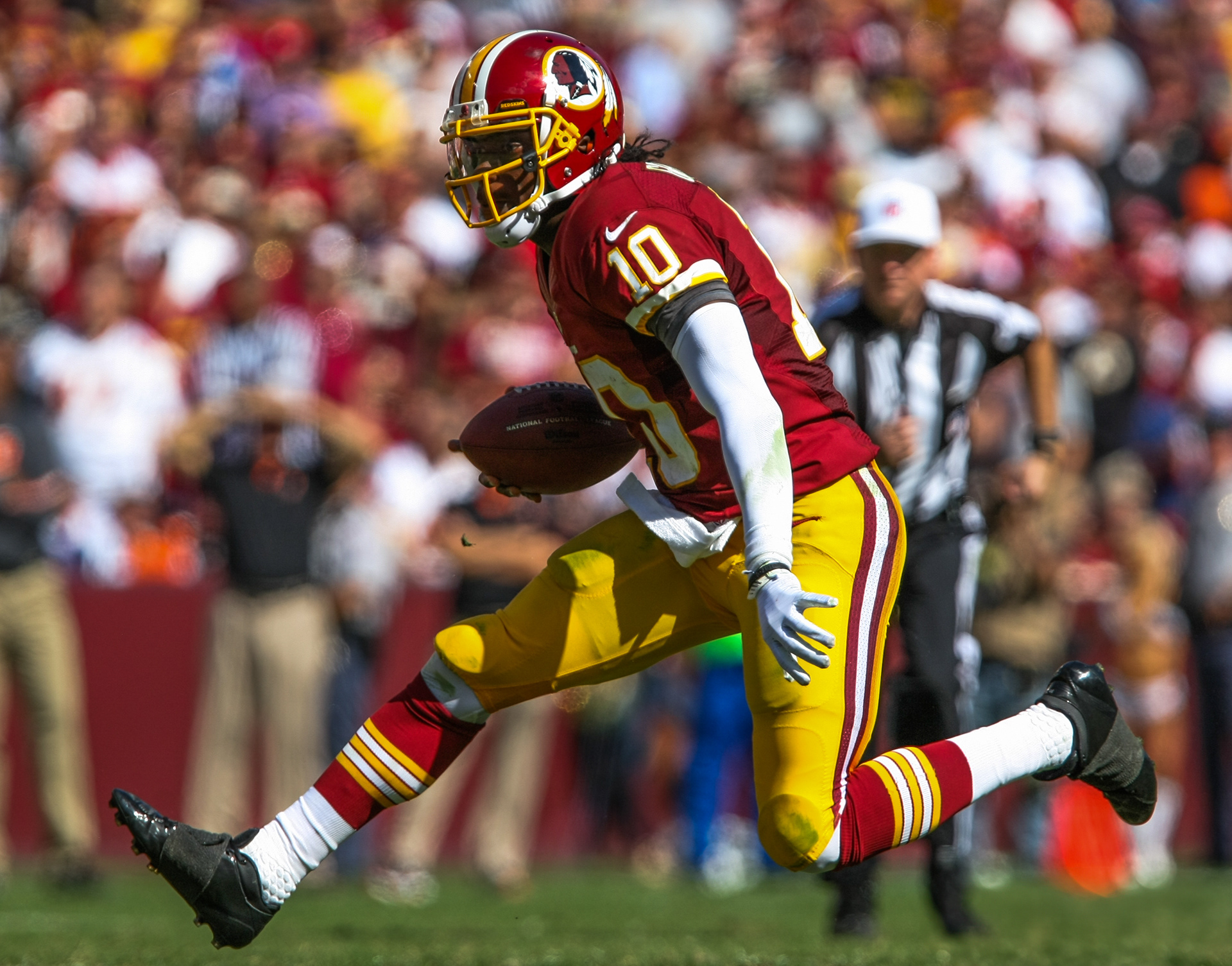 Washington quarterback Robert Griffin III runs with the football during an NFL football game at FedEx Field in Landover, MD