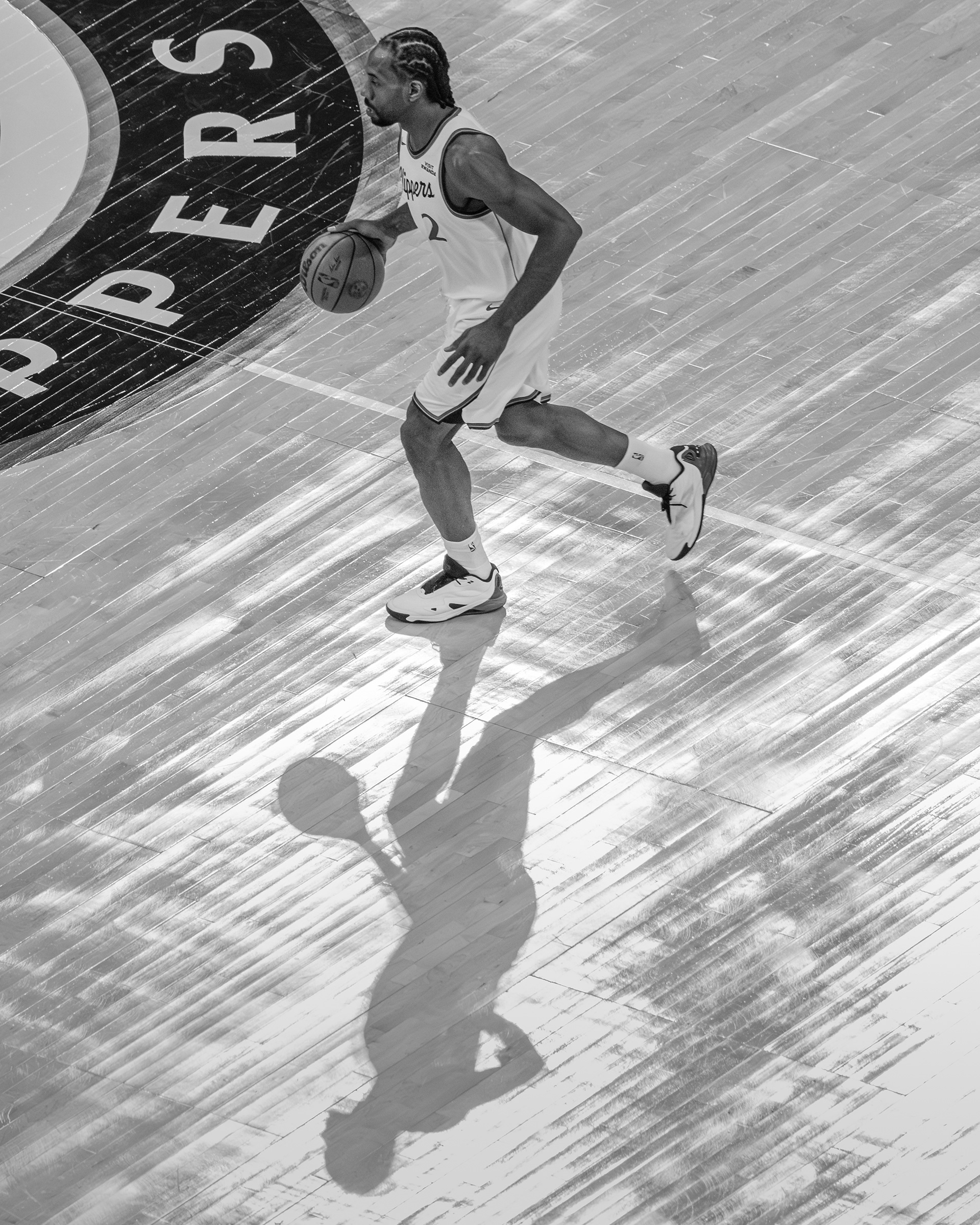 LA Clippers forward Kawhi Leonard dribbles the ball up the court during an NBA basketball game at Intuit Dome in Los Angeles, CA
