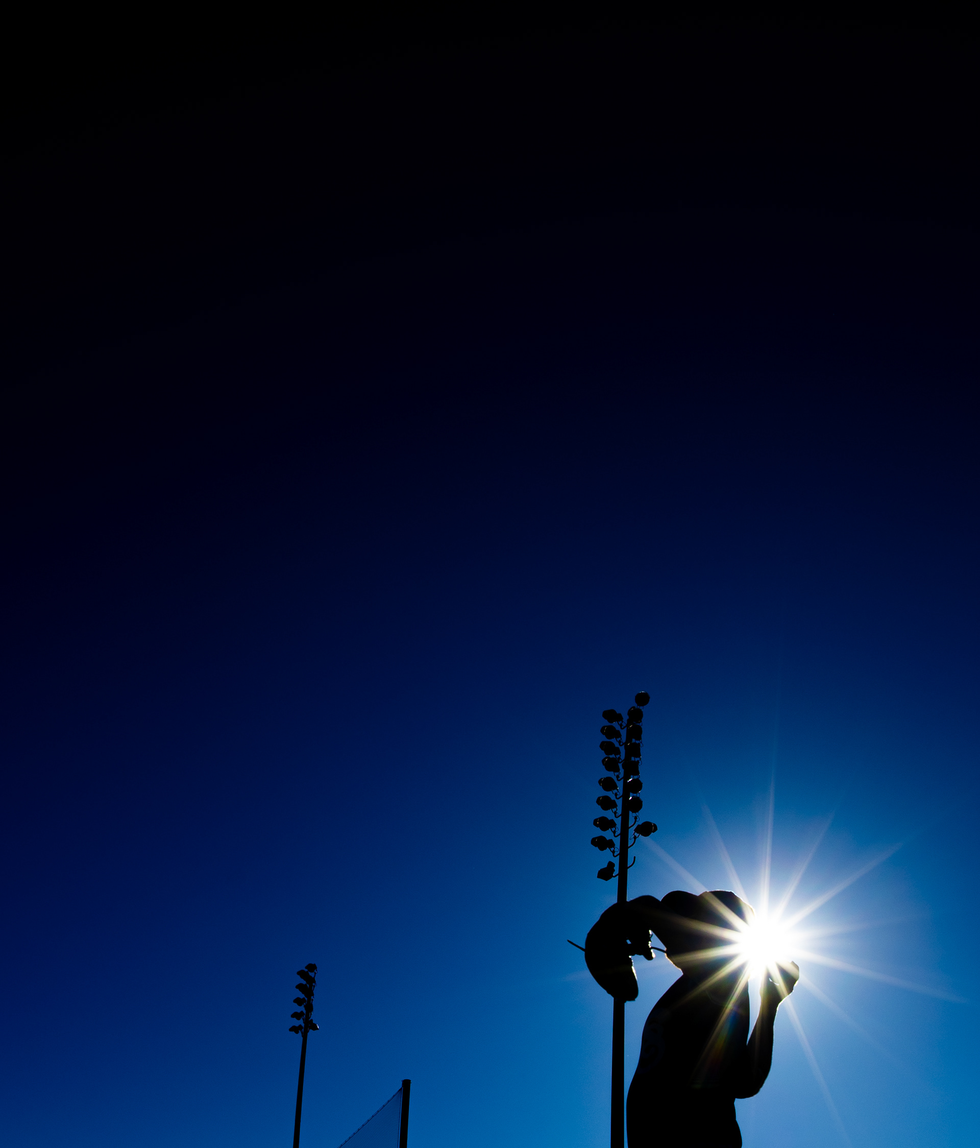 College baseball player warms up before a California Collegiate League baseball game at Jackie Robinson Field in Pasadena, CA