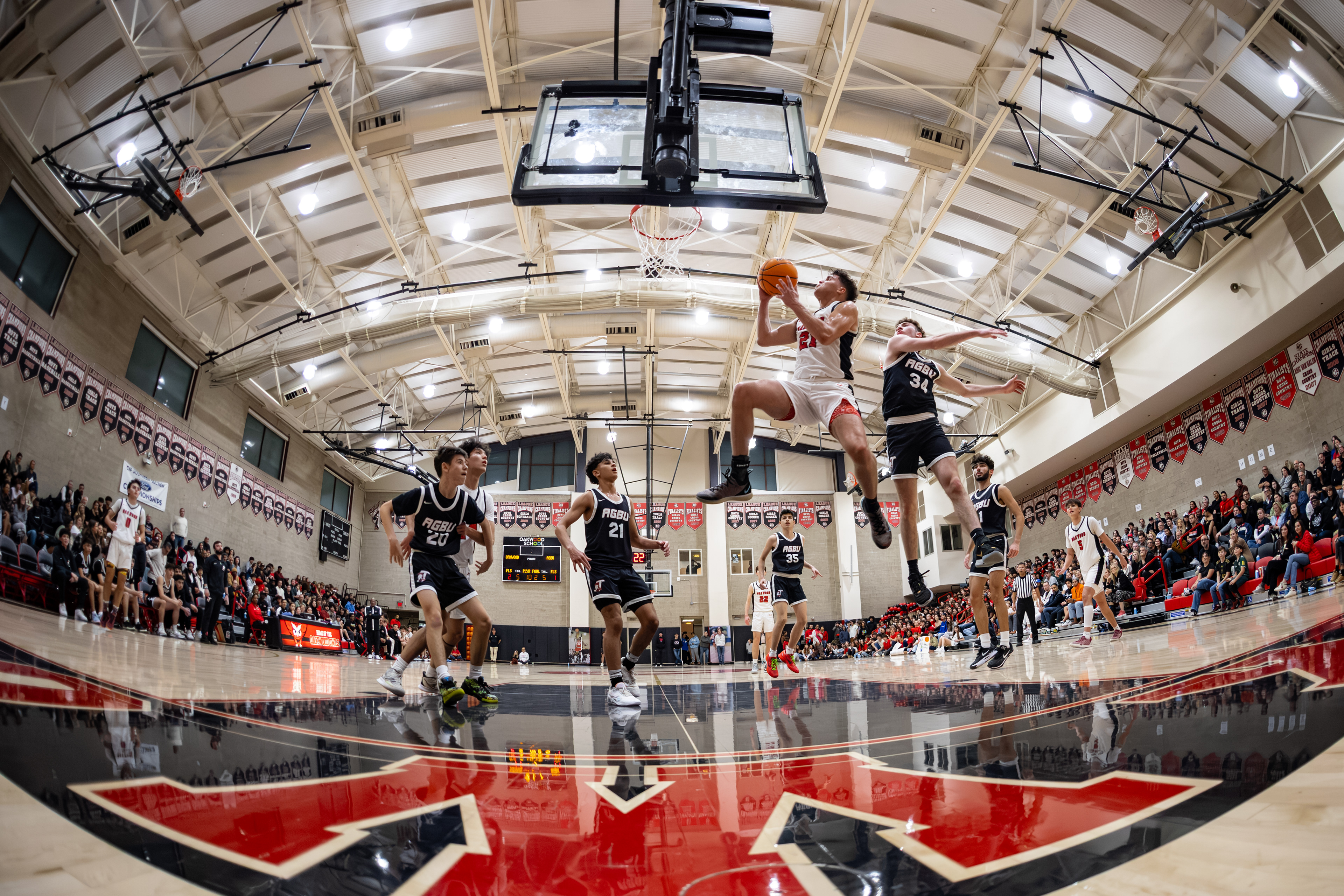 Oakwood basketball player drives towards the rim during a high school basketball game.