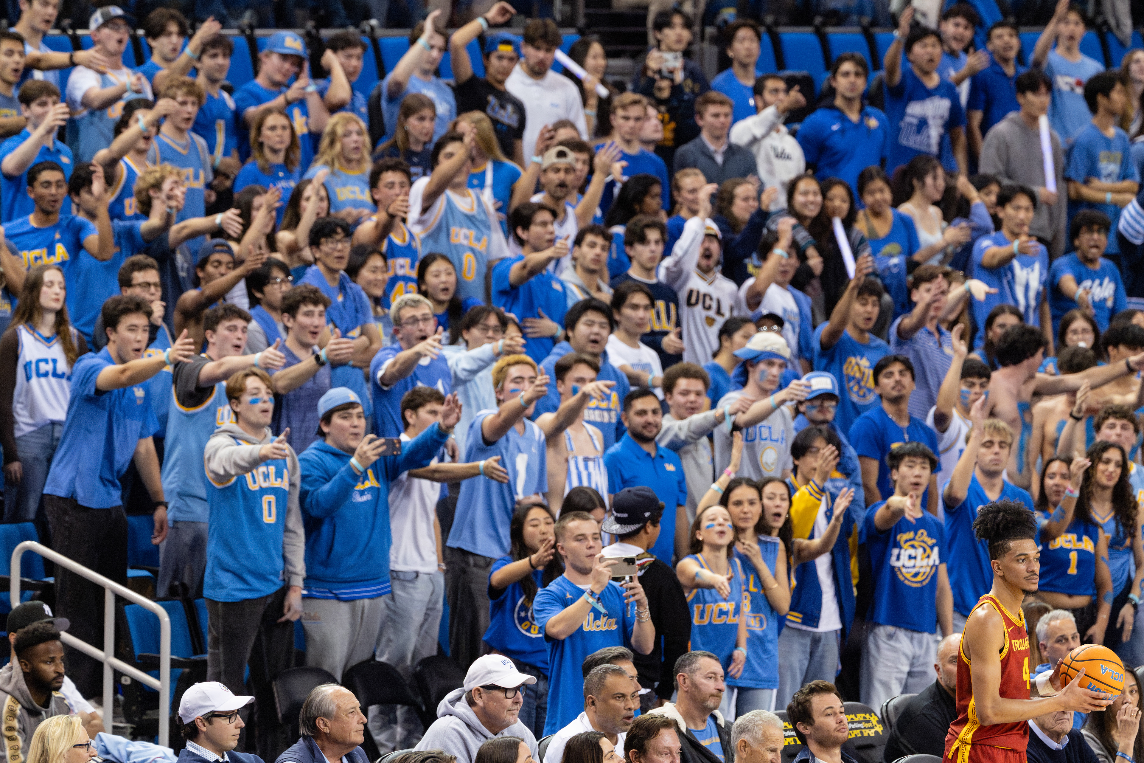 UCLA students cheer and point at USC guard Chad Baker-Mazara during an NCAA basketball game at Pauley Pavilion in Los Angeles, CA