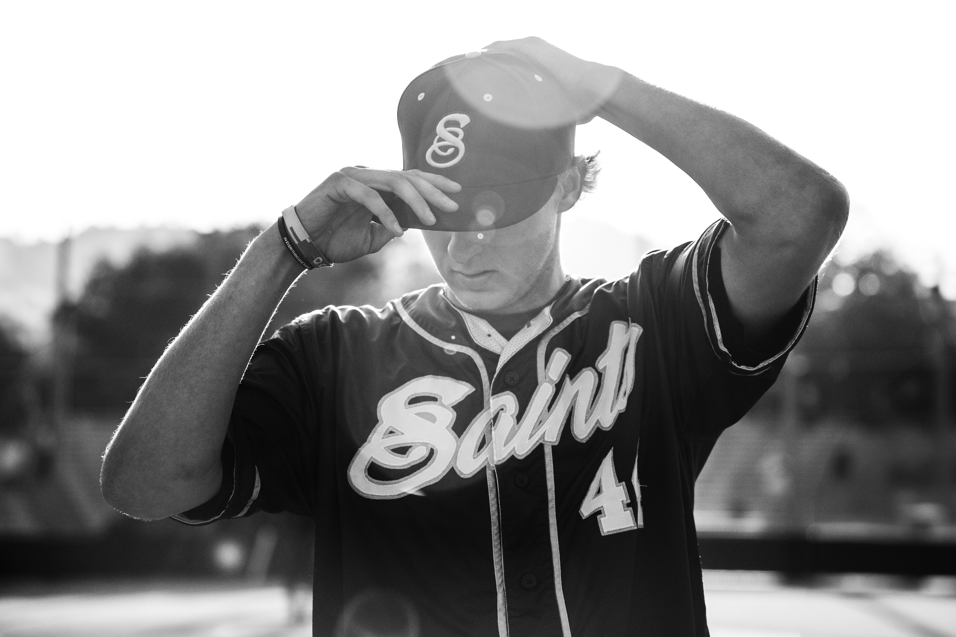 College baseball player adjusts his cap before a California Collegiate League baseball game at Jackie Robinson Stadium in Pasadena, CA