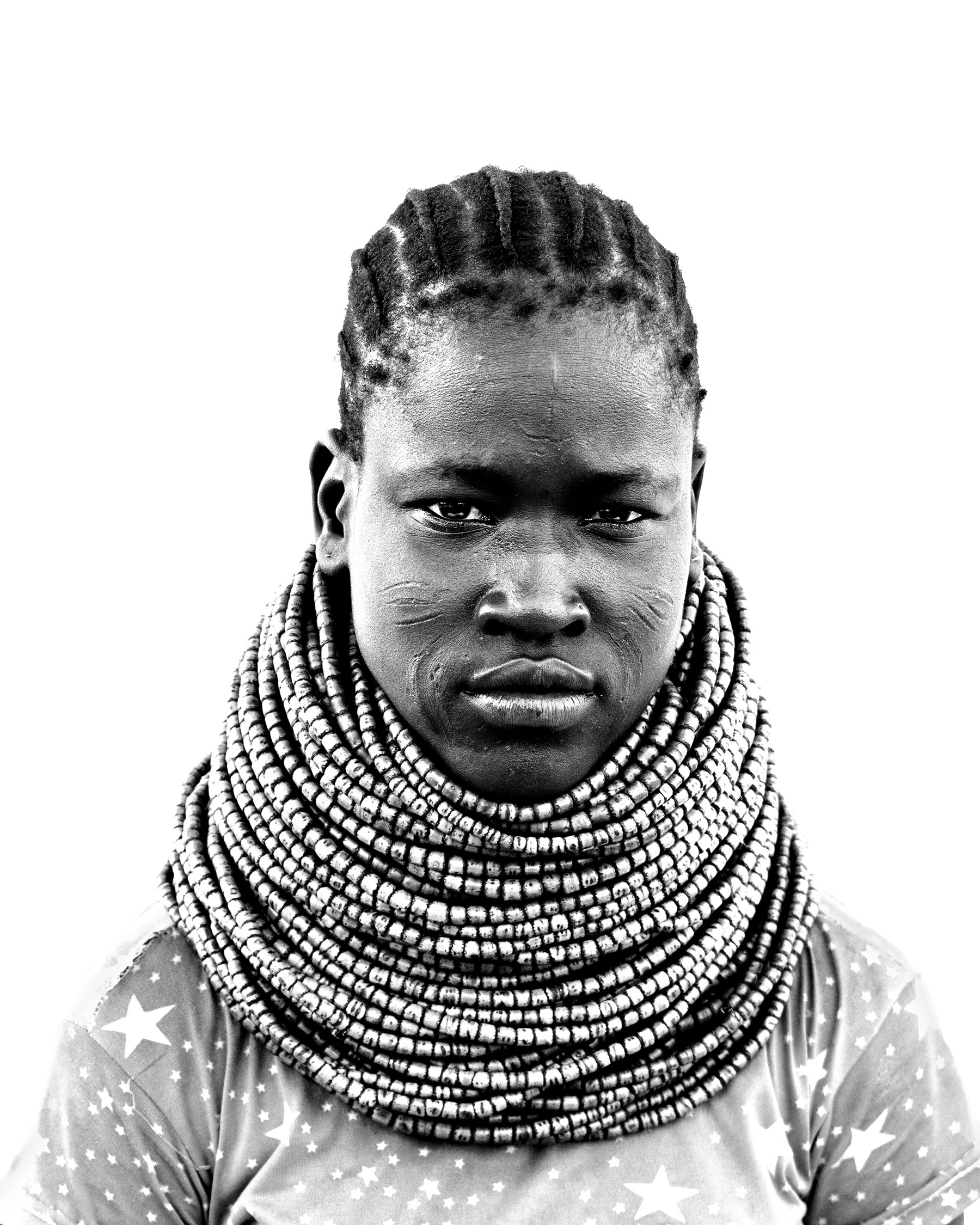 Black and white portrait of a young woman from the Nyangatom community, Lower Omo Valley, Ethiopia, 2025.