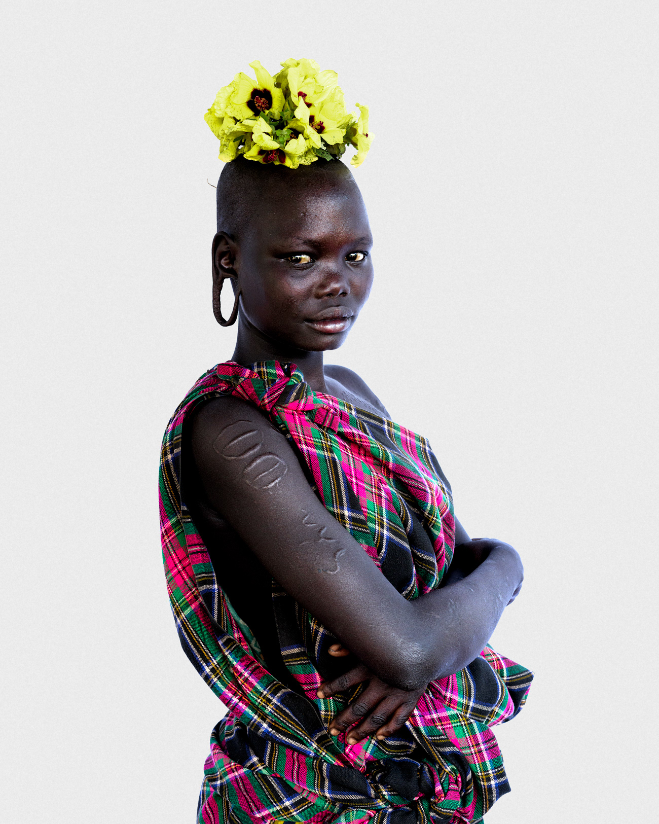 Portrait of a young woman from the Suri community wearing traditional adornments, Lower Omo Valley, Ethiopia, 2025.
