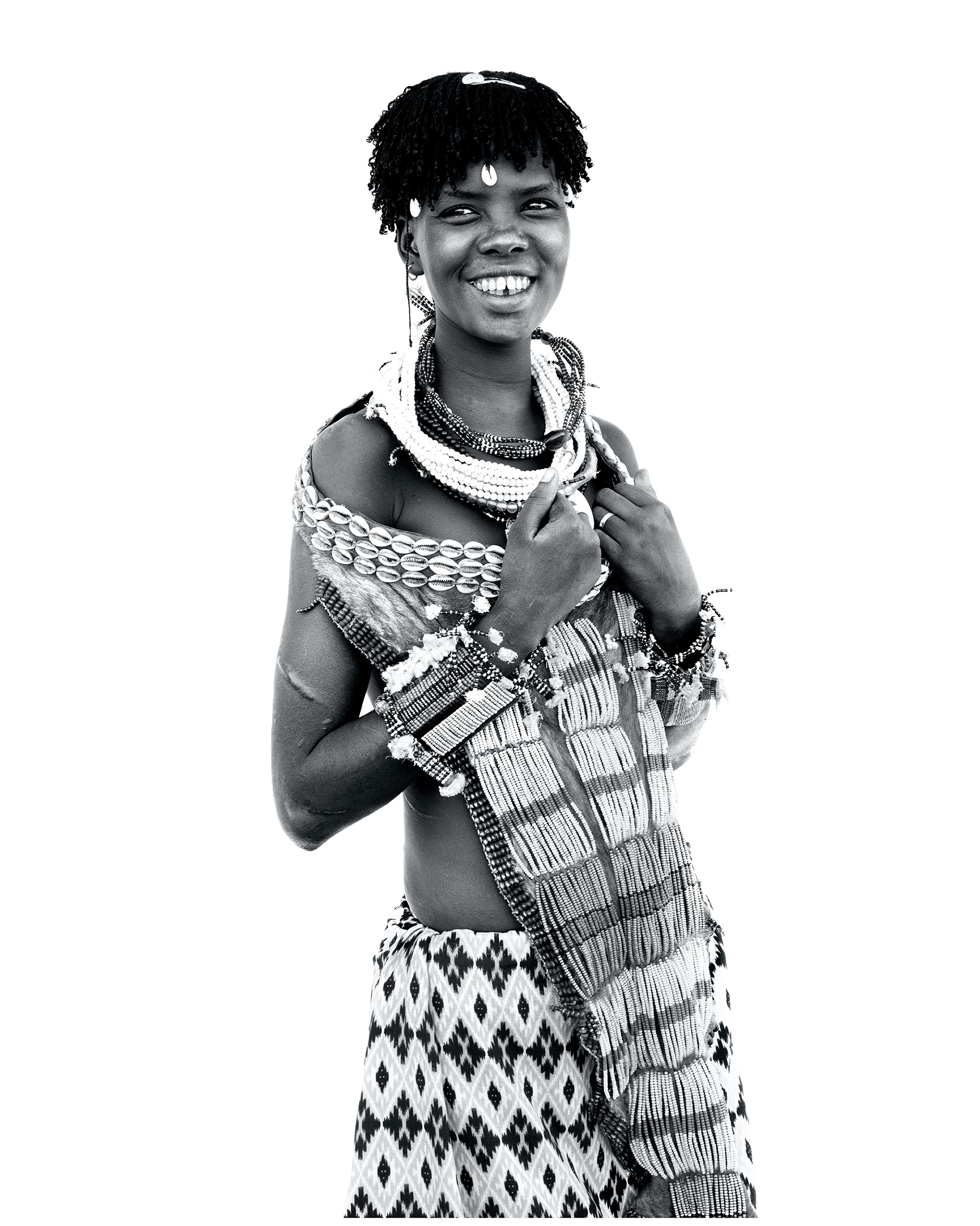 Black and white portrait of a young woman from the Hamer community, Lower Omo Valley, Ethiopia, 2025.
