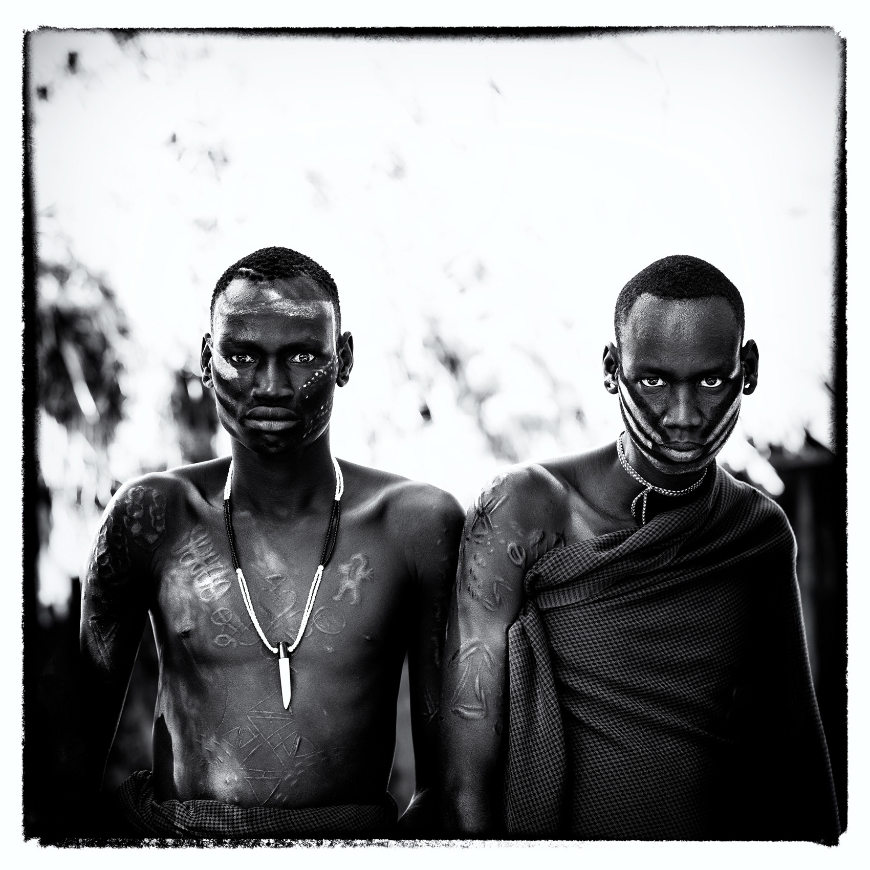 Black and white portrait of two men from the Mursi community, Lower Omo Valley, Ethiopia, 2025.