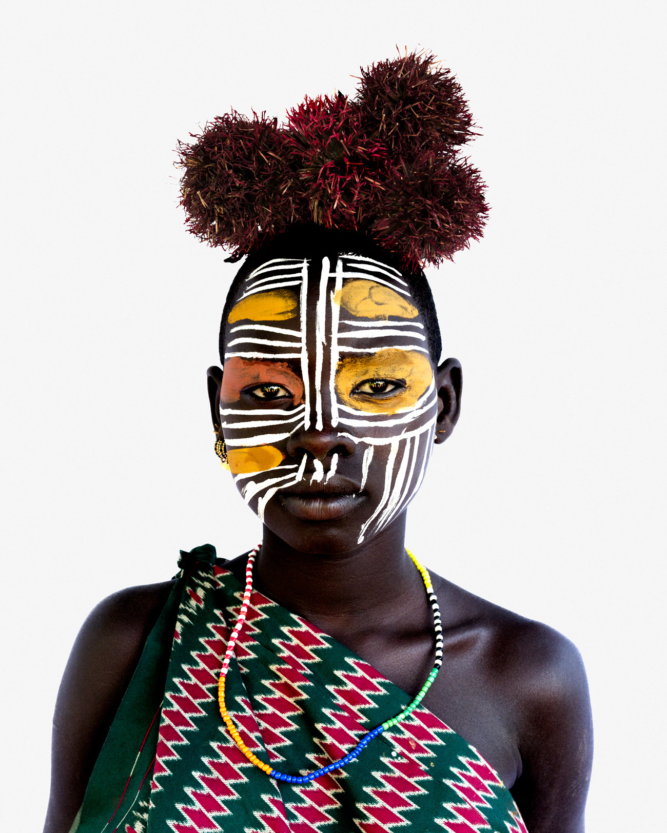 Portrait of a young woman from the Suri community with traditional face painting, Lower Omo Valley, Ethiopia, 2025.