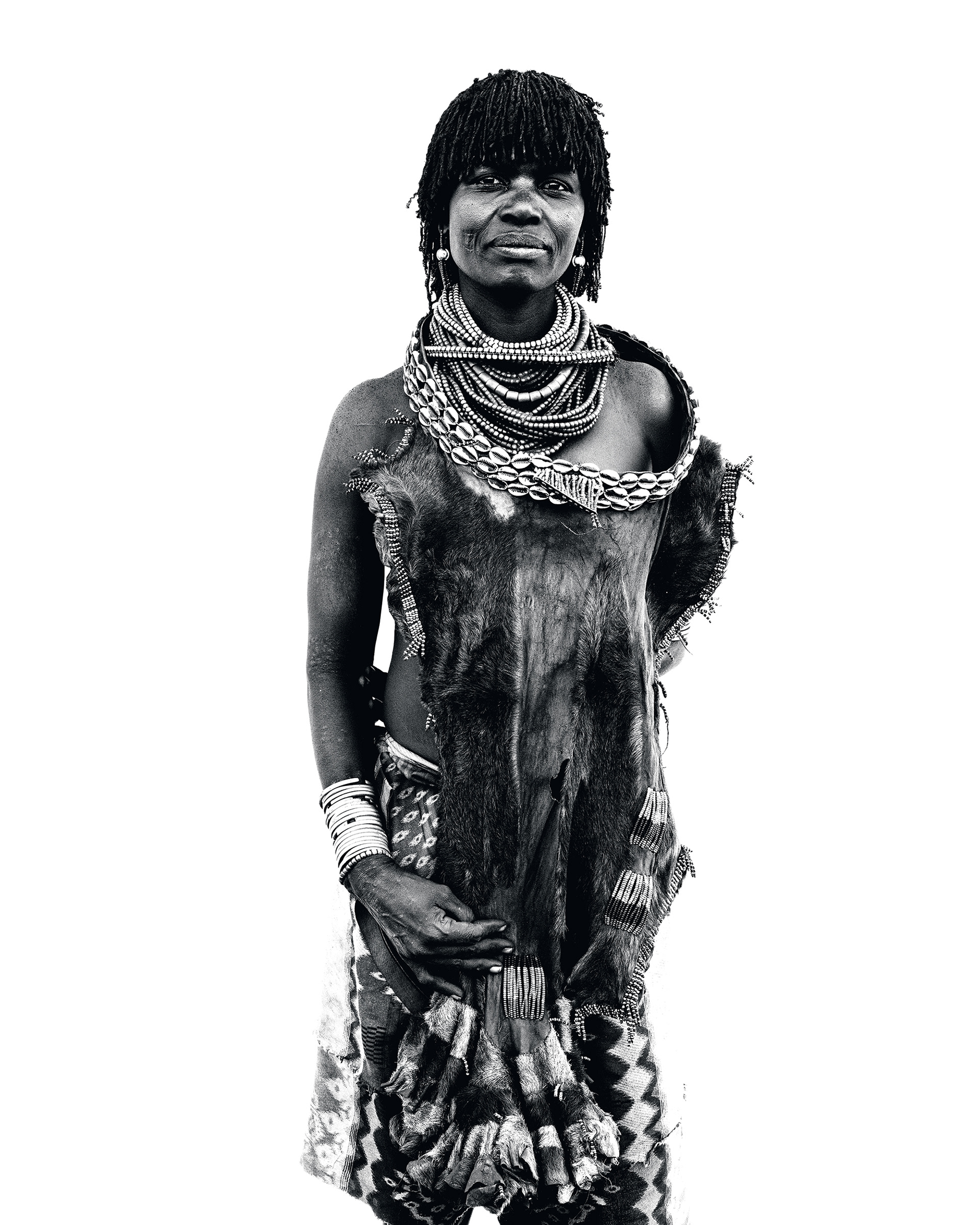 Black and white portrait of a woman from the Hamer community wearing traditional adornments, Lower Omo Valley, Ethiopia, 2025.