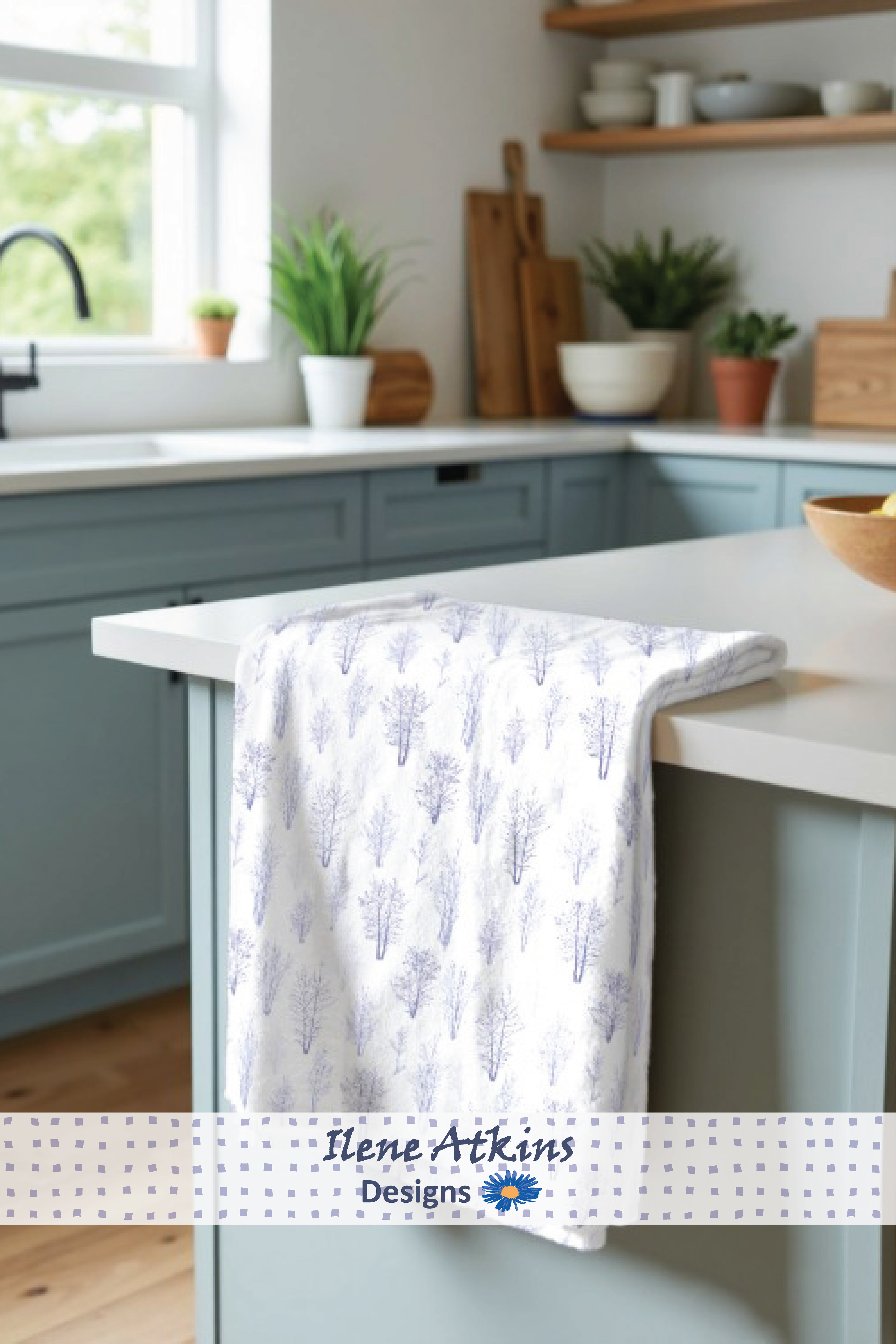 The Winter Silhouette Pattern from the Winter Woodland Collection by Ilene Atkins Designs, featured on a crisp teatowel placed in an elegant and modern kitchen setting 