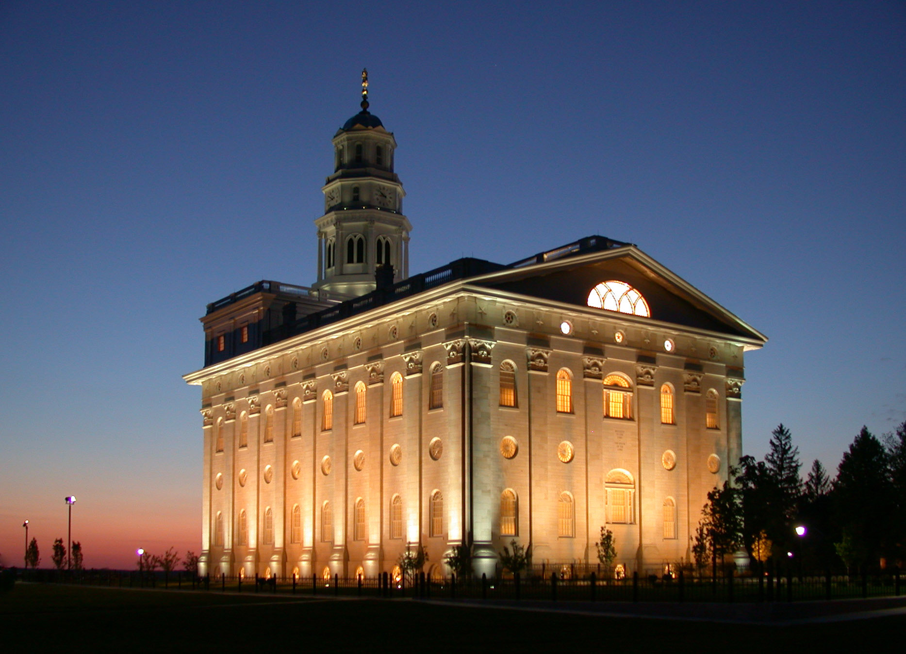LDS temple in Nauvoo, glowing at dusk.