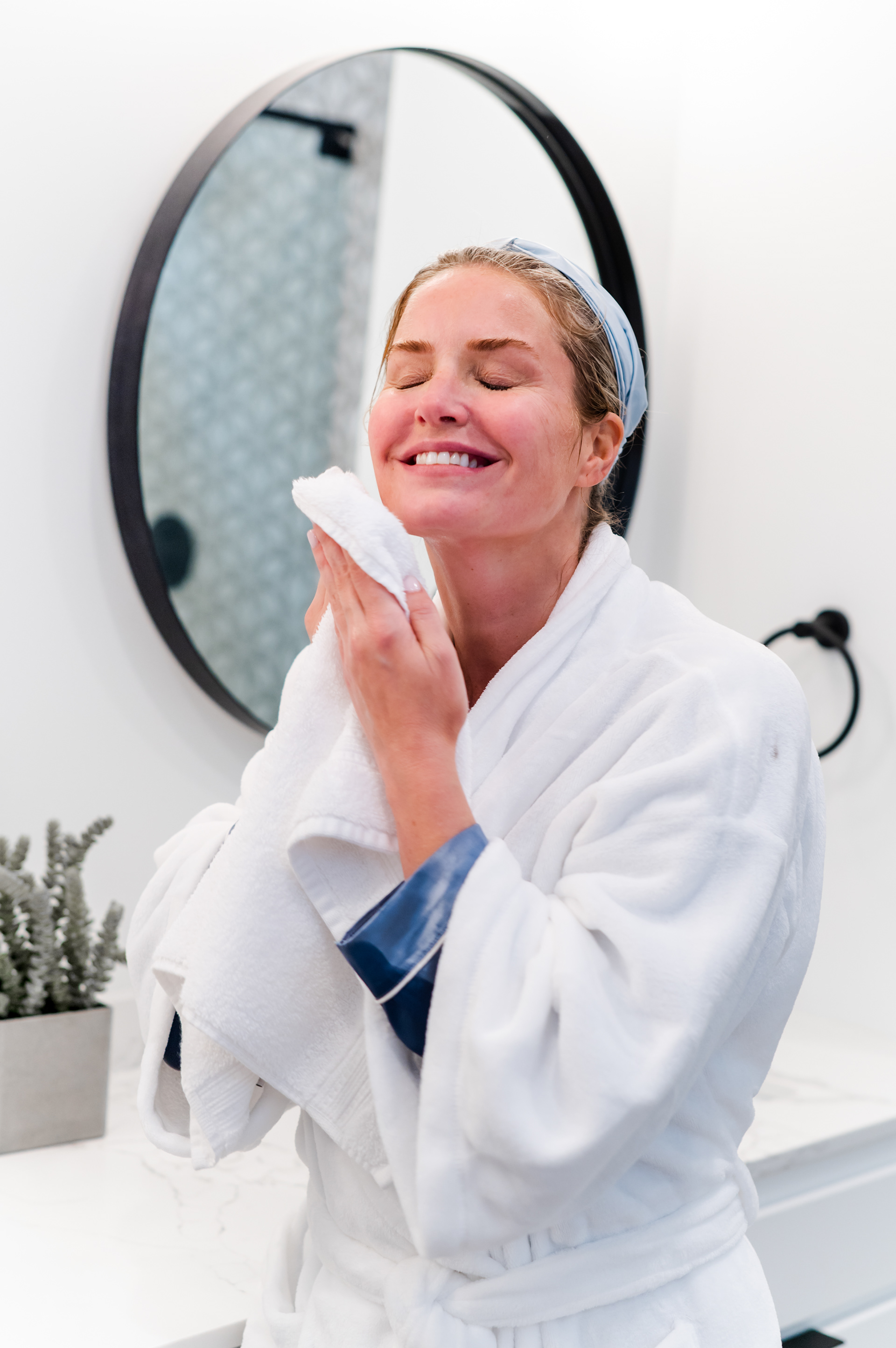 Skincare model drying her face with a white towel