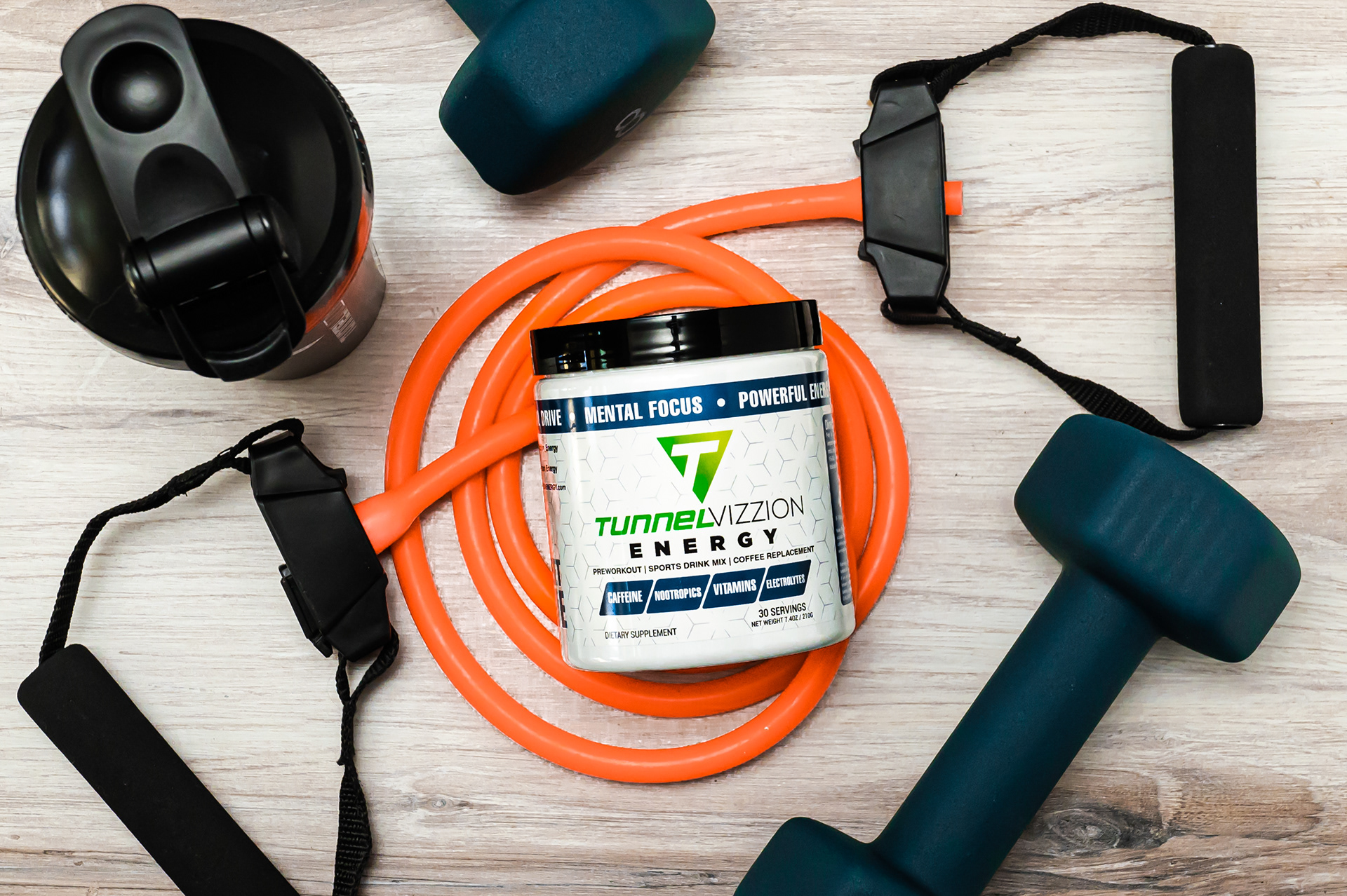 Tunnel Vizzion Energy can on gym floor with shaker bottle, bands and hand weights