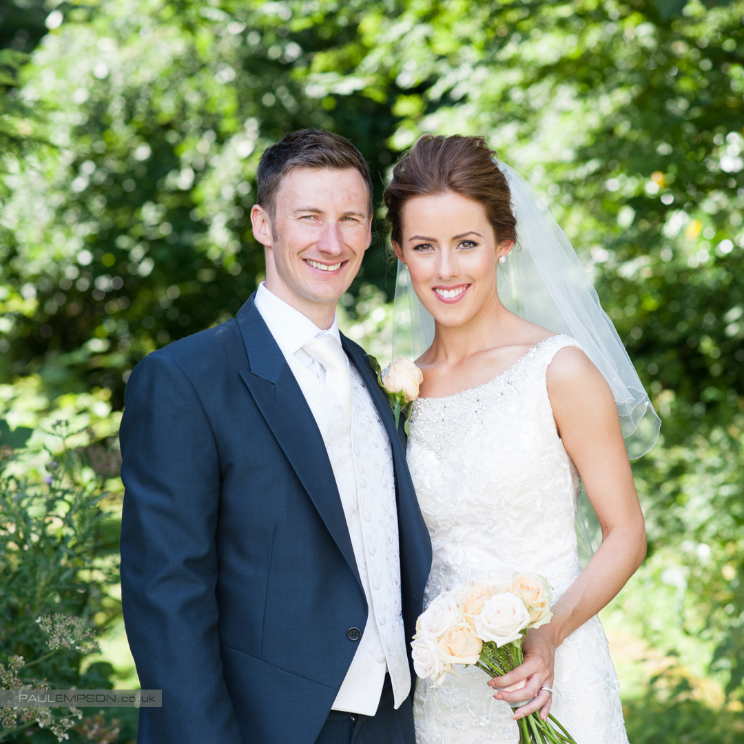 Solberge Hall summer wedding a smiling bride & groom in the grounds hold each other close