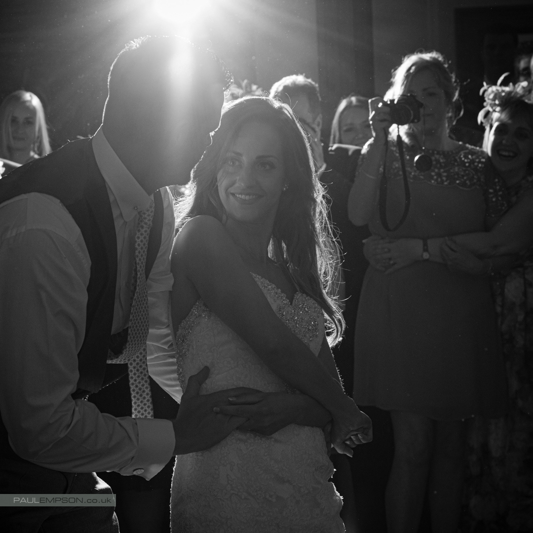 Rudby Hall wedding first dance a smiling bride looks at her groom as the guests watch on