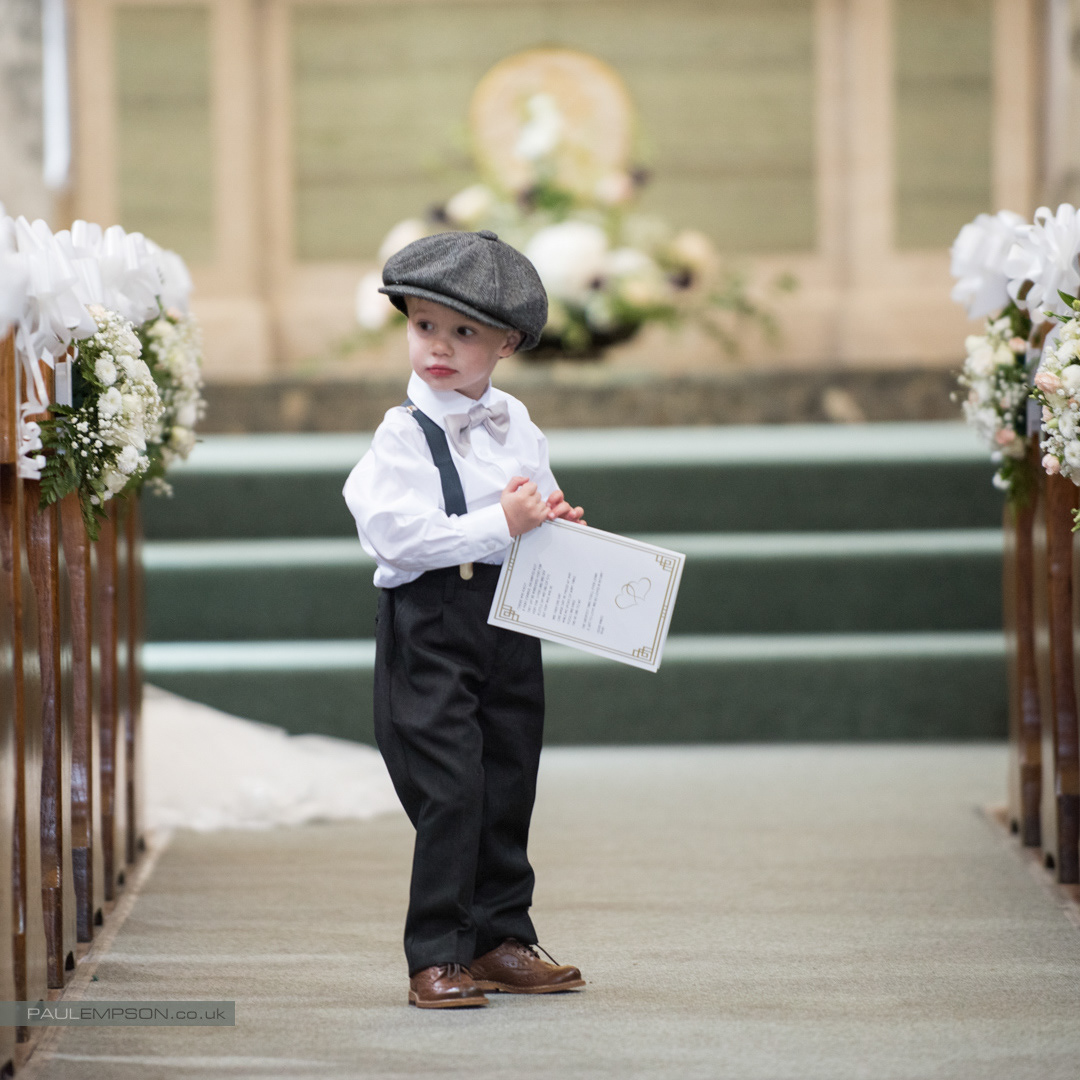 Middlesbrough wedding a page boy, wearing cap & braces, in the church aisle