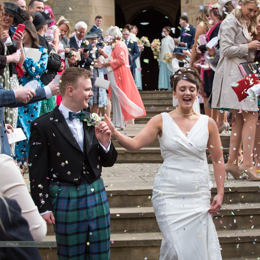 Barnard Castle Wedding celebrations, smiling bride & groom showered in confetti by their guests