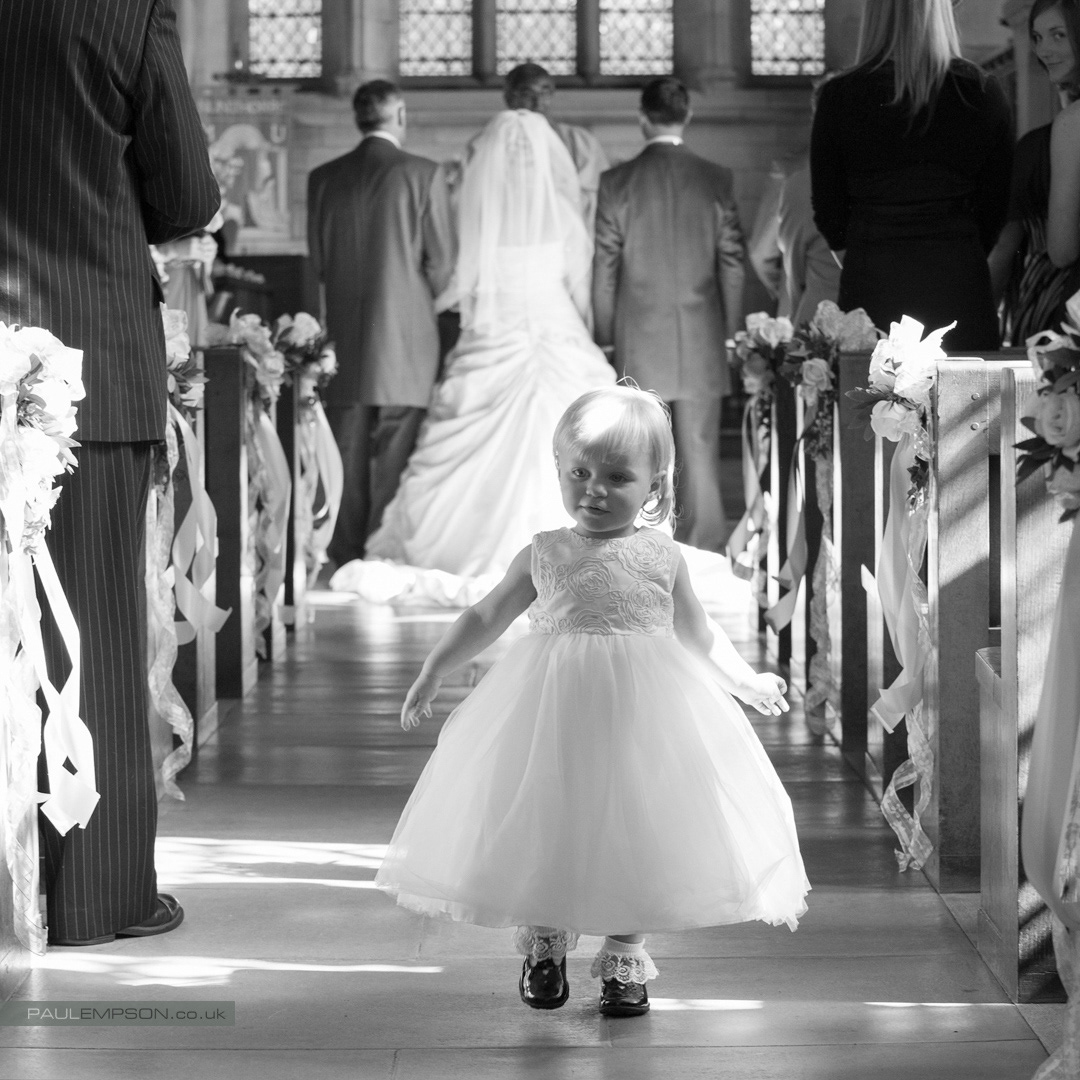 St Mary's church Nunthorpe Middlesbrough a Little flower girl wanders down the church aisle during the wedding ceremony