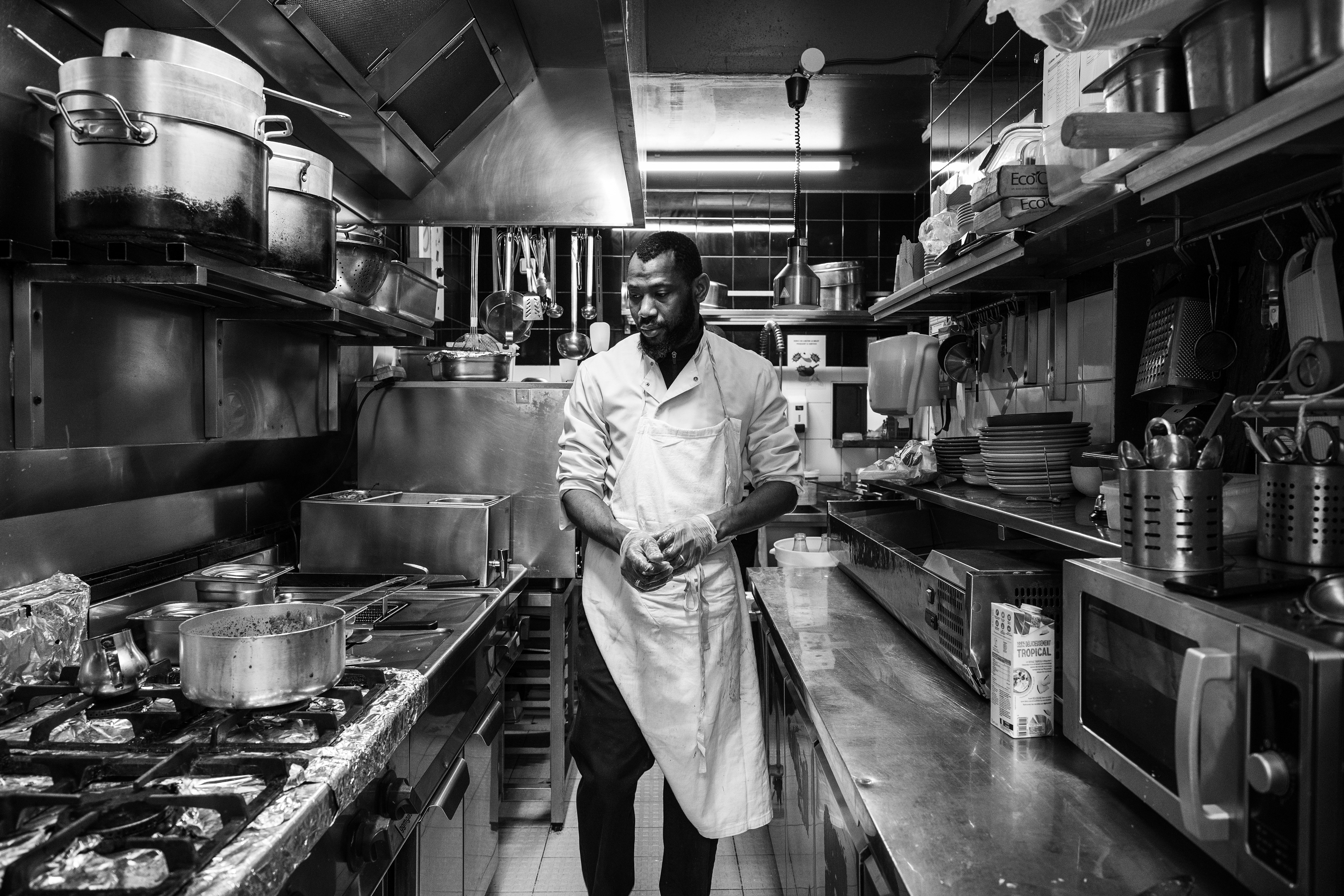 Simaro, head chef at BMK Folie Bamako, checks that the dish is cooking properly whilst preparing a ravitoto (a dish made from pounded cassava leaves cooked in coconut milk) on 5 February 2026 in Paris (11th arrondissement), France.
