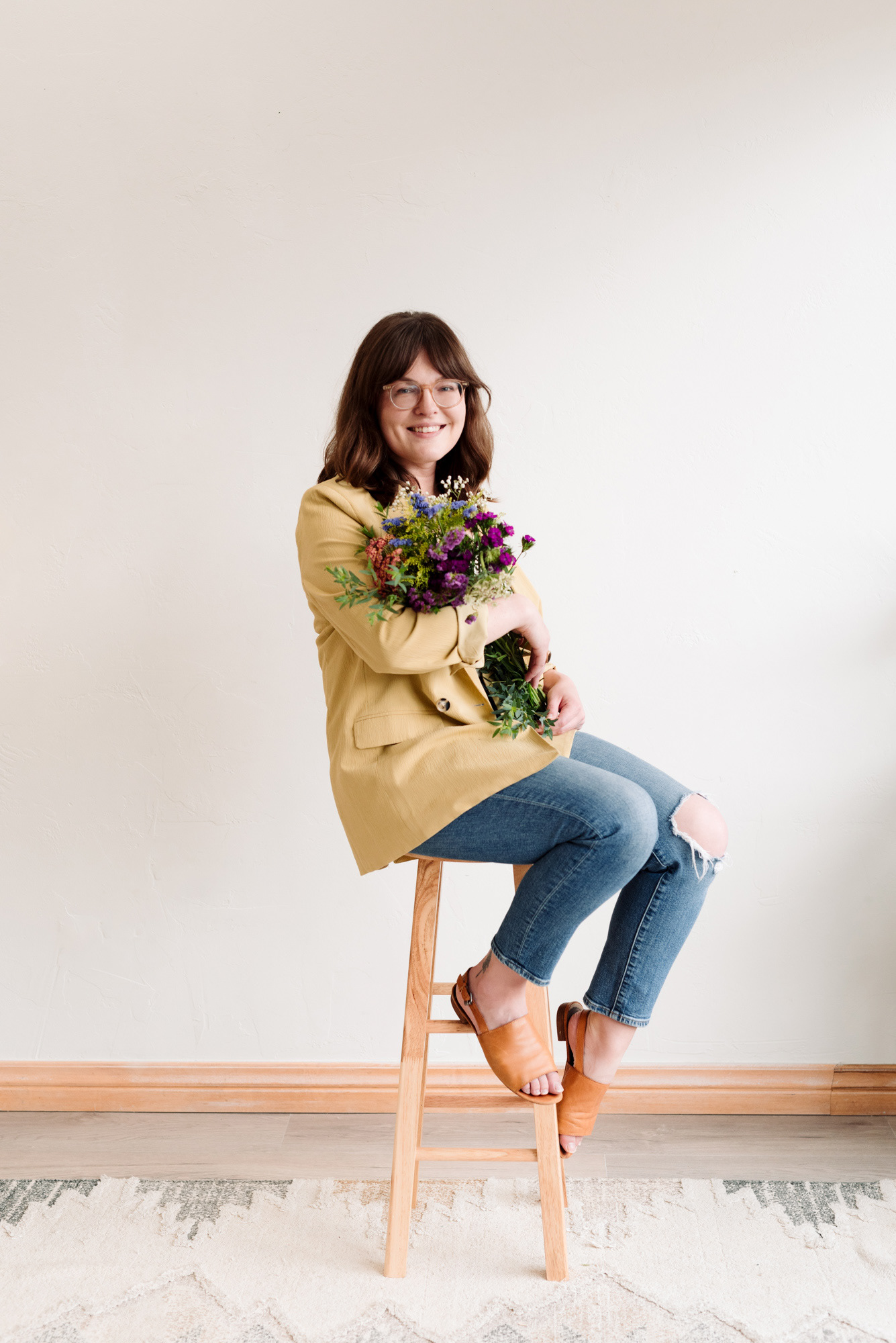 Portrait of a woman sitting with a bunch of flowers