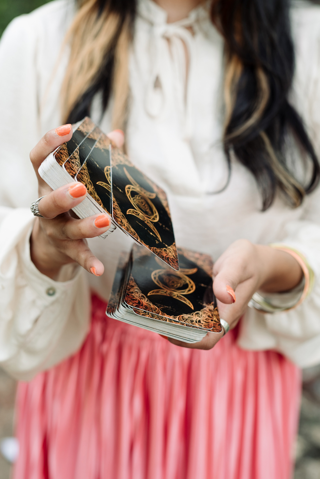 Woman shuffling tarot cards for a branding photoshoot in Colorado Springs.