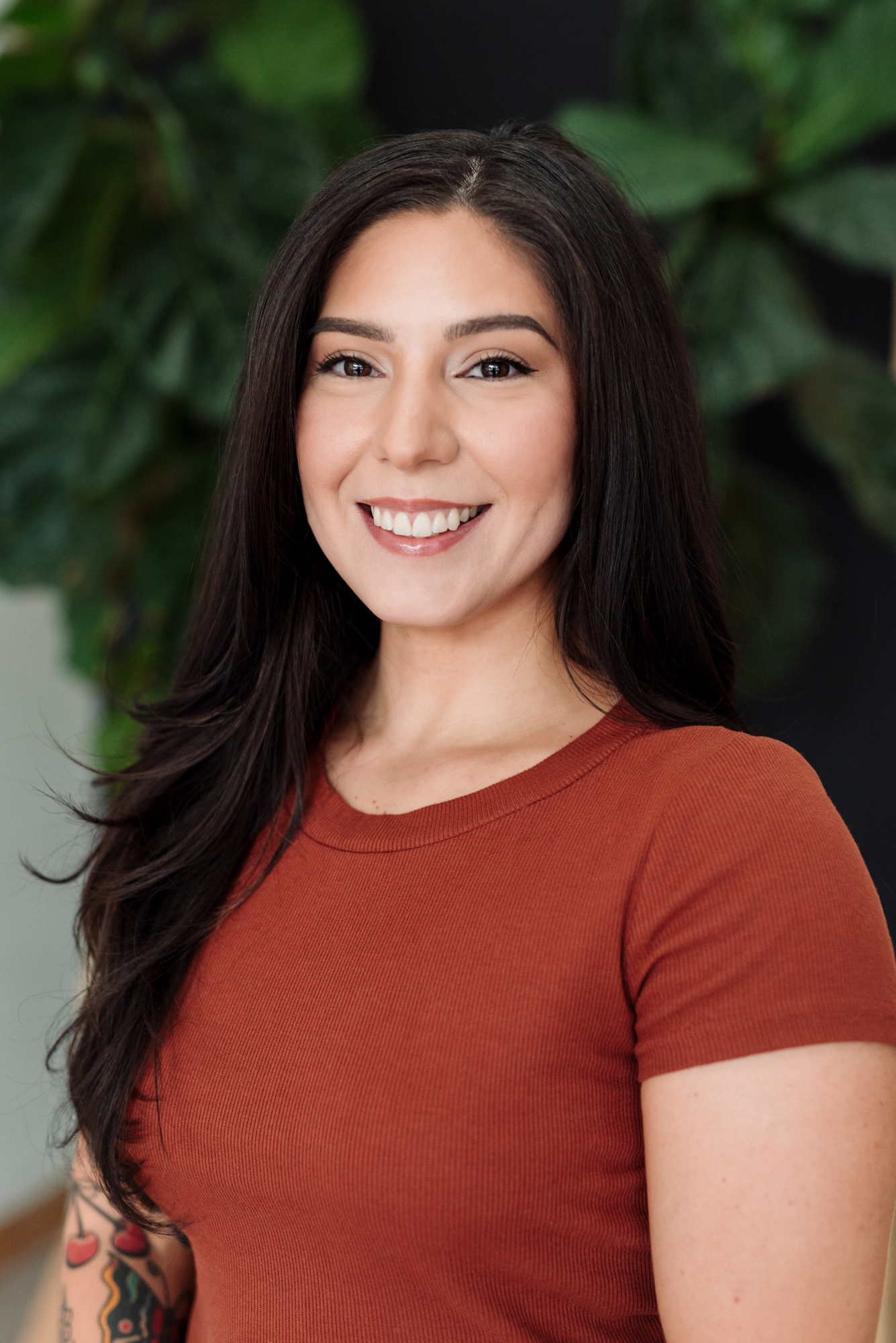 Headshot photograph of a personal trainer with tattoos.