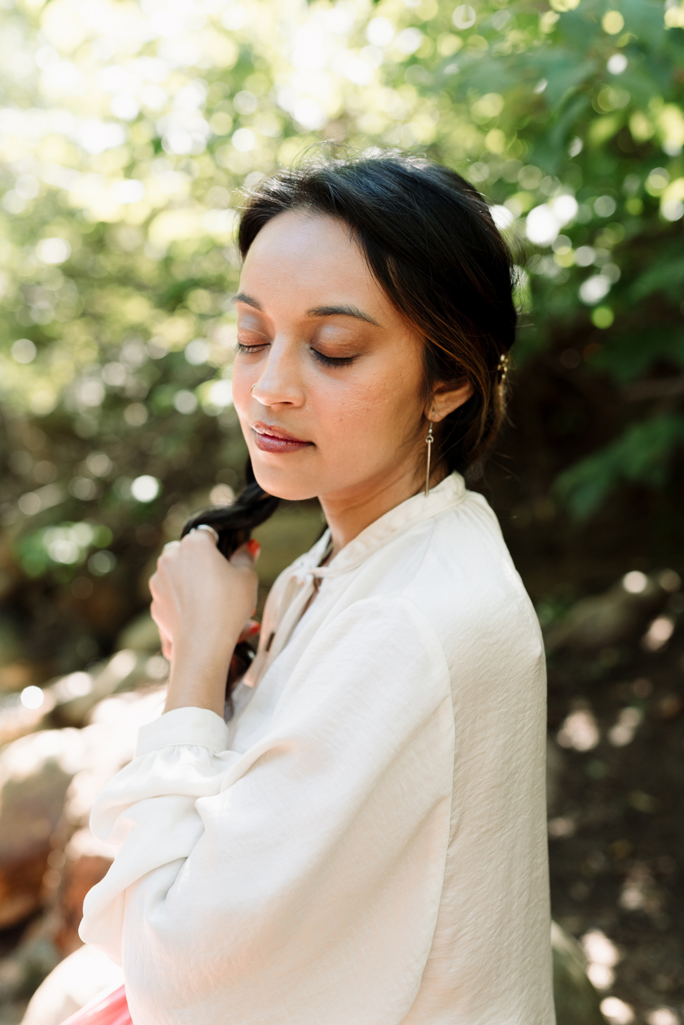 Woman with long hair with her eyes closed looking peaceful.