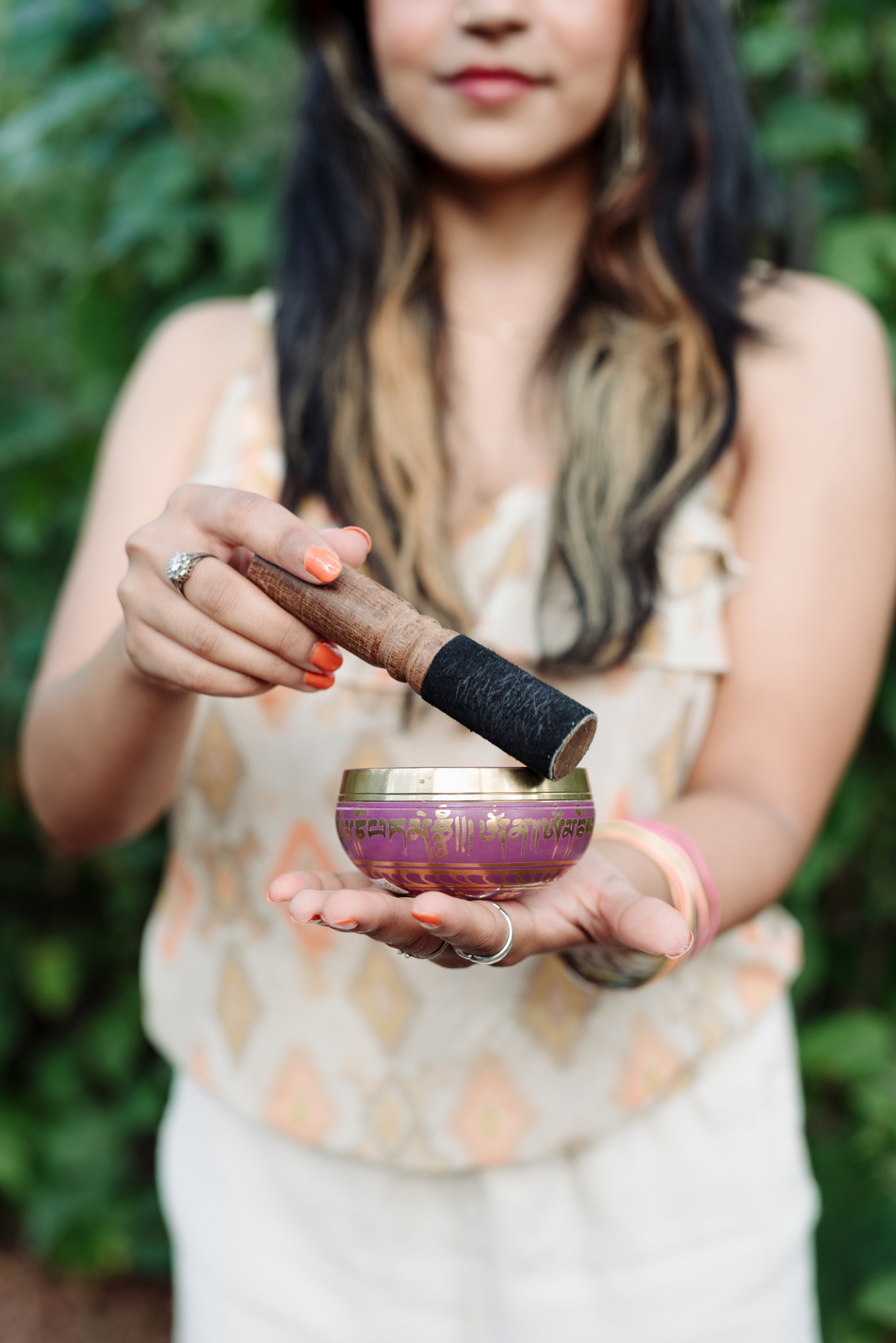 Woman using a singing bowl in a personal branding photoshoot.