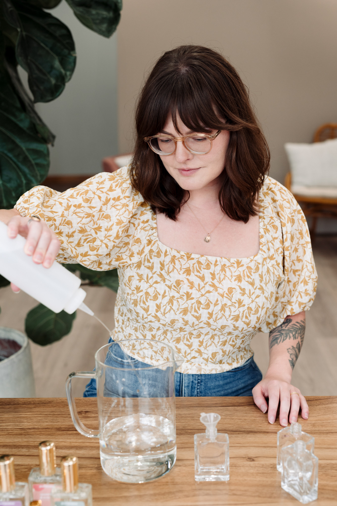 A woman mixing ingredients to make perfume.