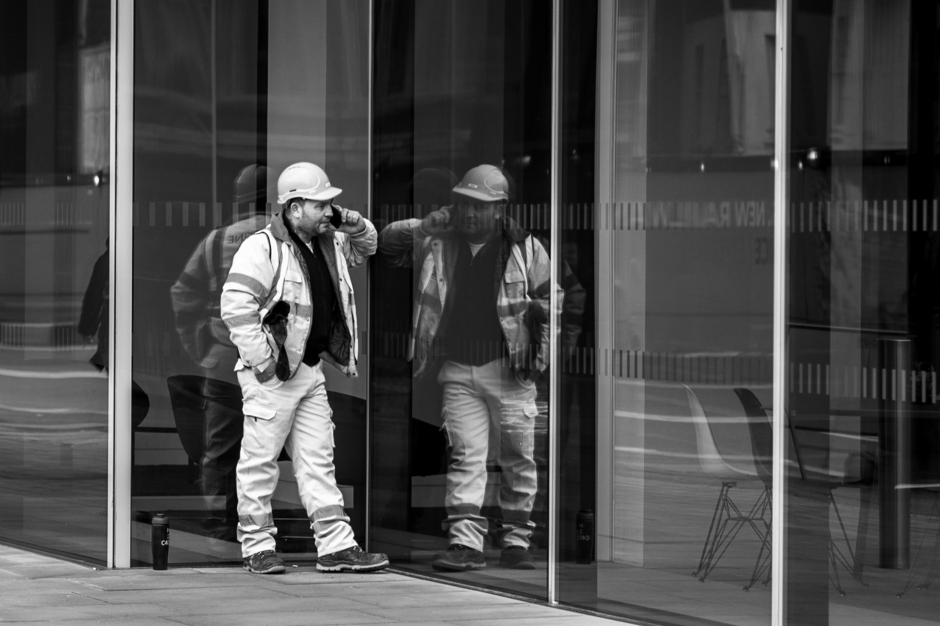 I love the reflection of this workman in the glass building.