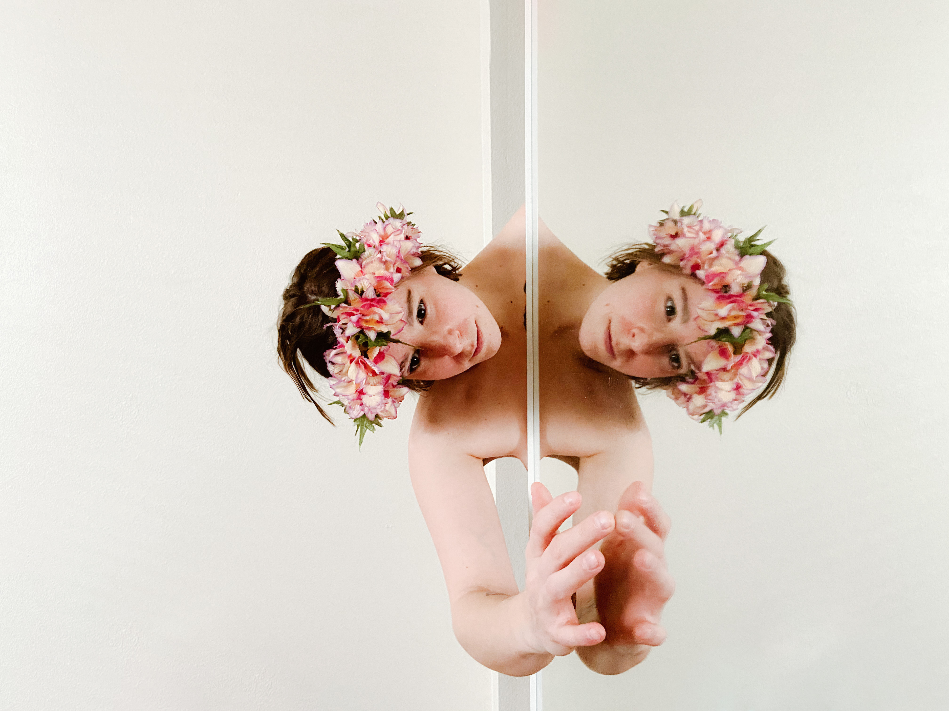 Image Description: the portrait of Sami topless behind the mirror with the same pose in reflection. Sami wore the flower crown.
