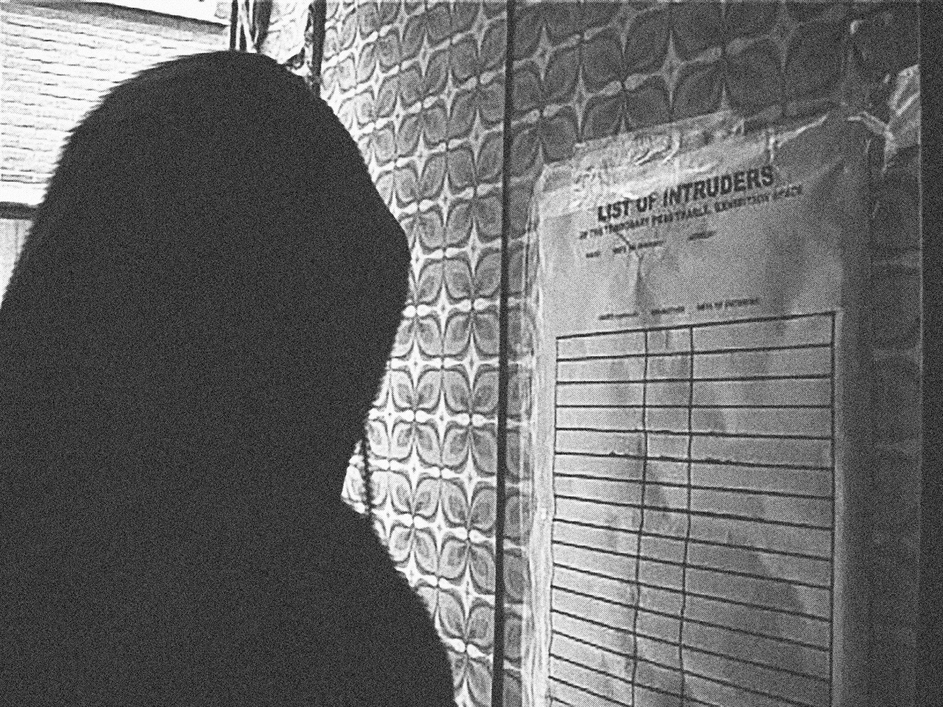 videostill of video footage filmed during the hanging of the 'List of Intruders' for T.P.E.S.022005