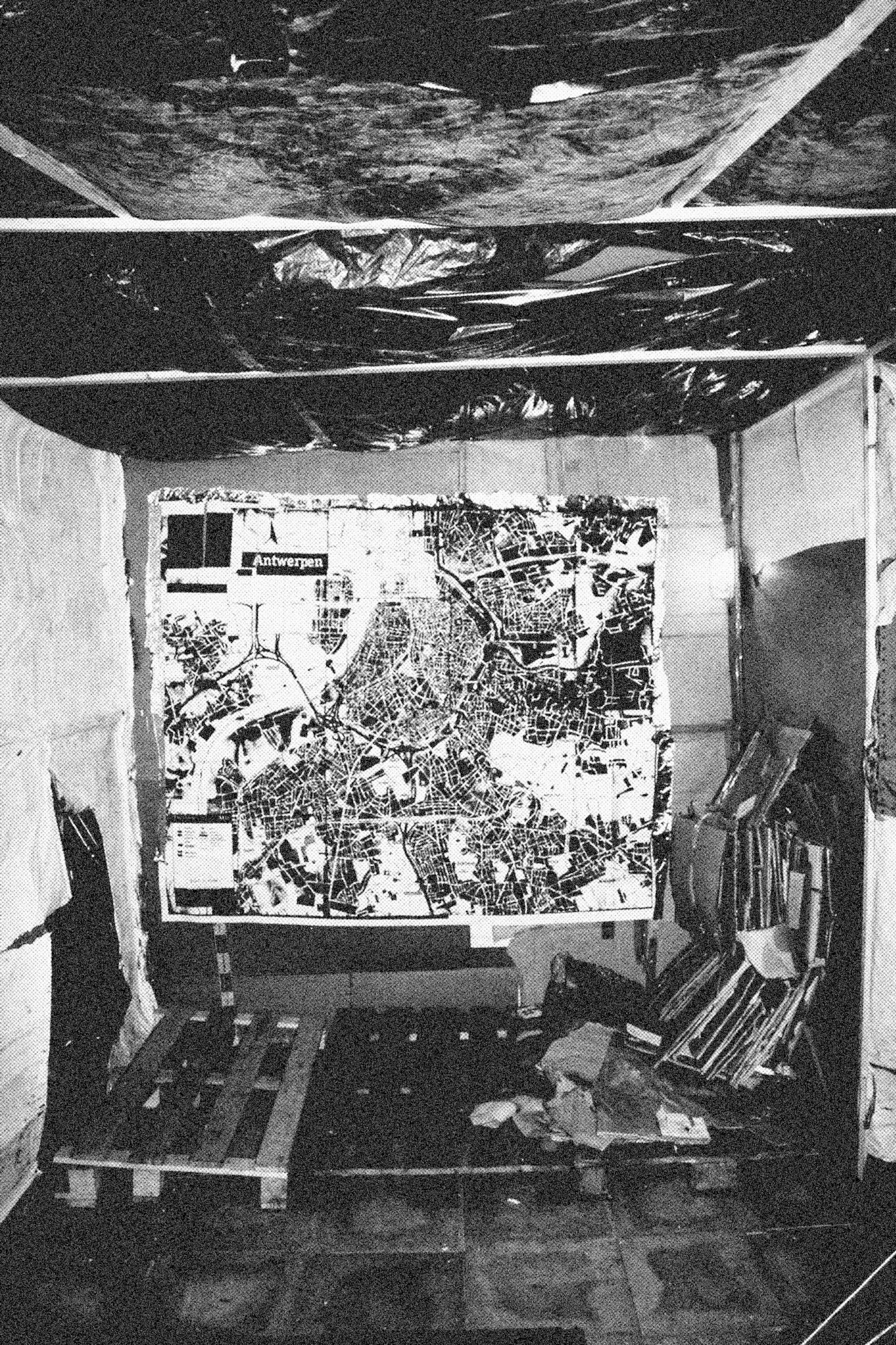 Reconstructed Constructioninstallationcardboard on wooden construction, silk screened wallpaper, tiled floor, carpet floor, electrical equipment: television, DVD-player, transmitter, lightning, plastic ridge tent, silkscreen materials, copy prints, iron case, bed mattress, buckets of latex paint.2006