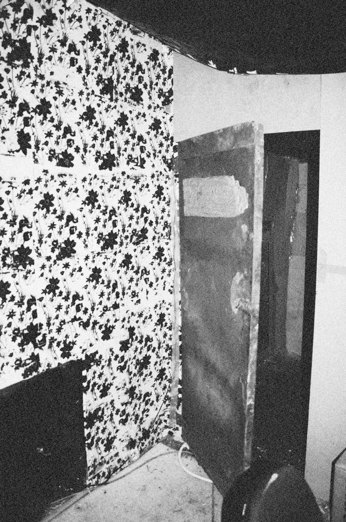 Reconstructed Constructioninstallationcardboard on wooden construction, silk screened wallpaper, tiled floor, carpet floor, electrical equipment: television, DVD-player, transmitter, lightning, plastic ridge tent, silkscreen materials, copy prints, iron case, bed mattress, buckets of latex paint.2006