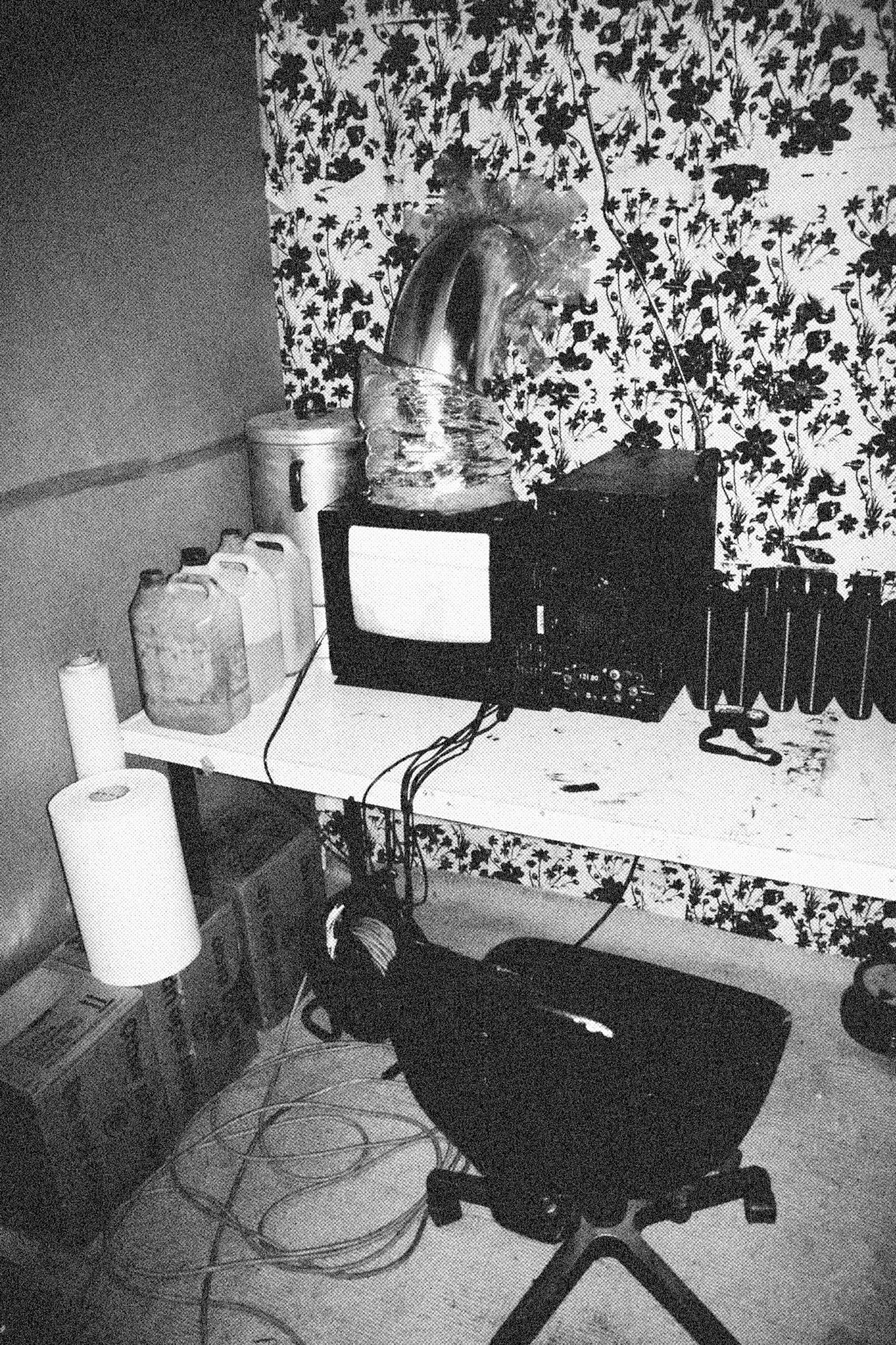 Reconstructed Constructioninstallationcardboard on wooden construction, silk screened wallpaper, tiled floor, carpet floor, electrical equipment: television, DVD-player, transmitter, lightning, plastic ridge tent, silkscreen materials, copy prints, iron case, bed mattress, buckets of latex paint.2006