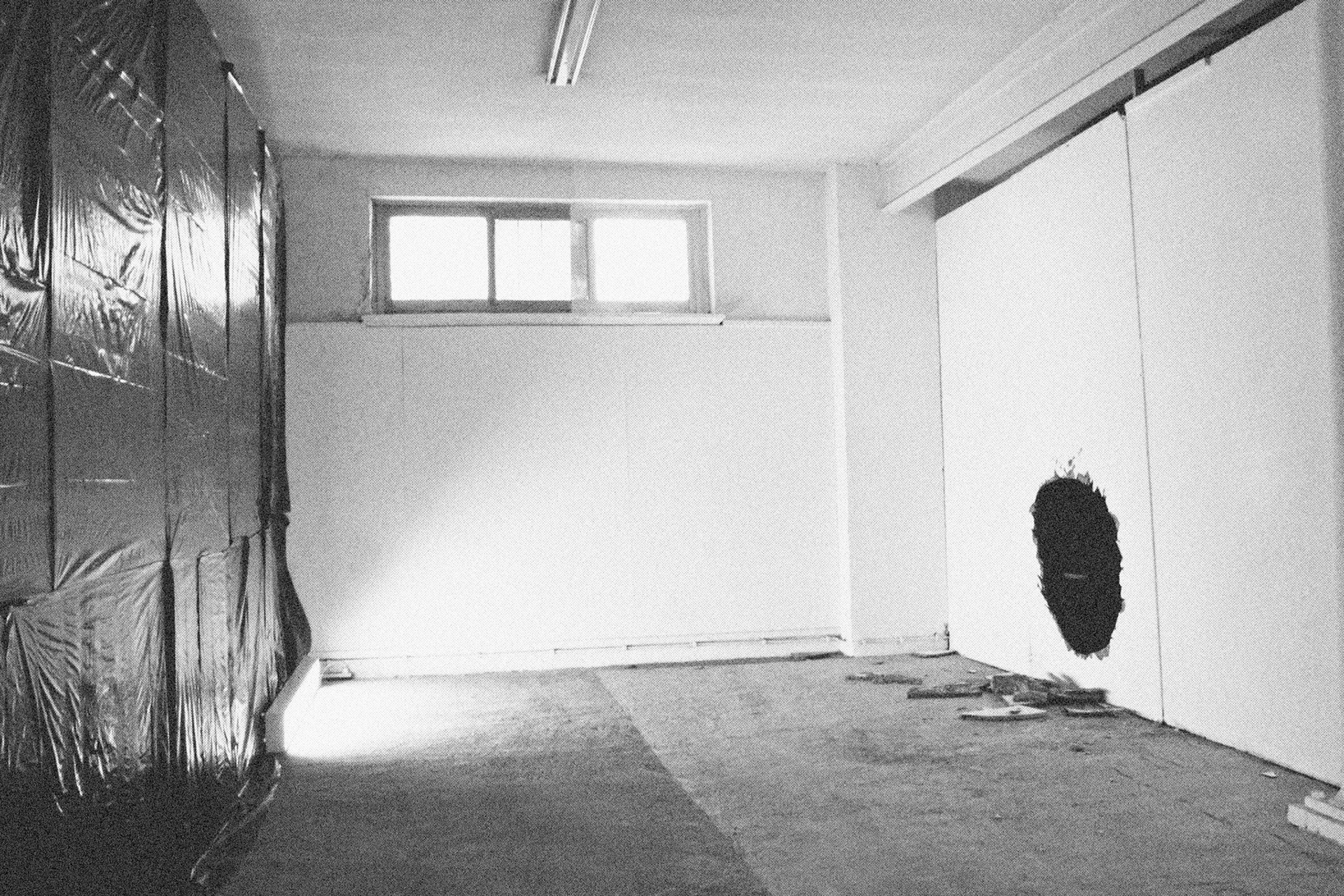 Reconstructed Constructioninstallationcardboard on wooden construction, silk screened wallpaper, tiled floor, carpet floor, electrical equipment: television, DVD-player, transmitter, lightning, plastic ridge tent, silkscreen materials, copy prints, iron case, bed mattress, buckets of latex paint.2006