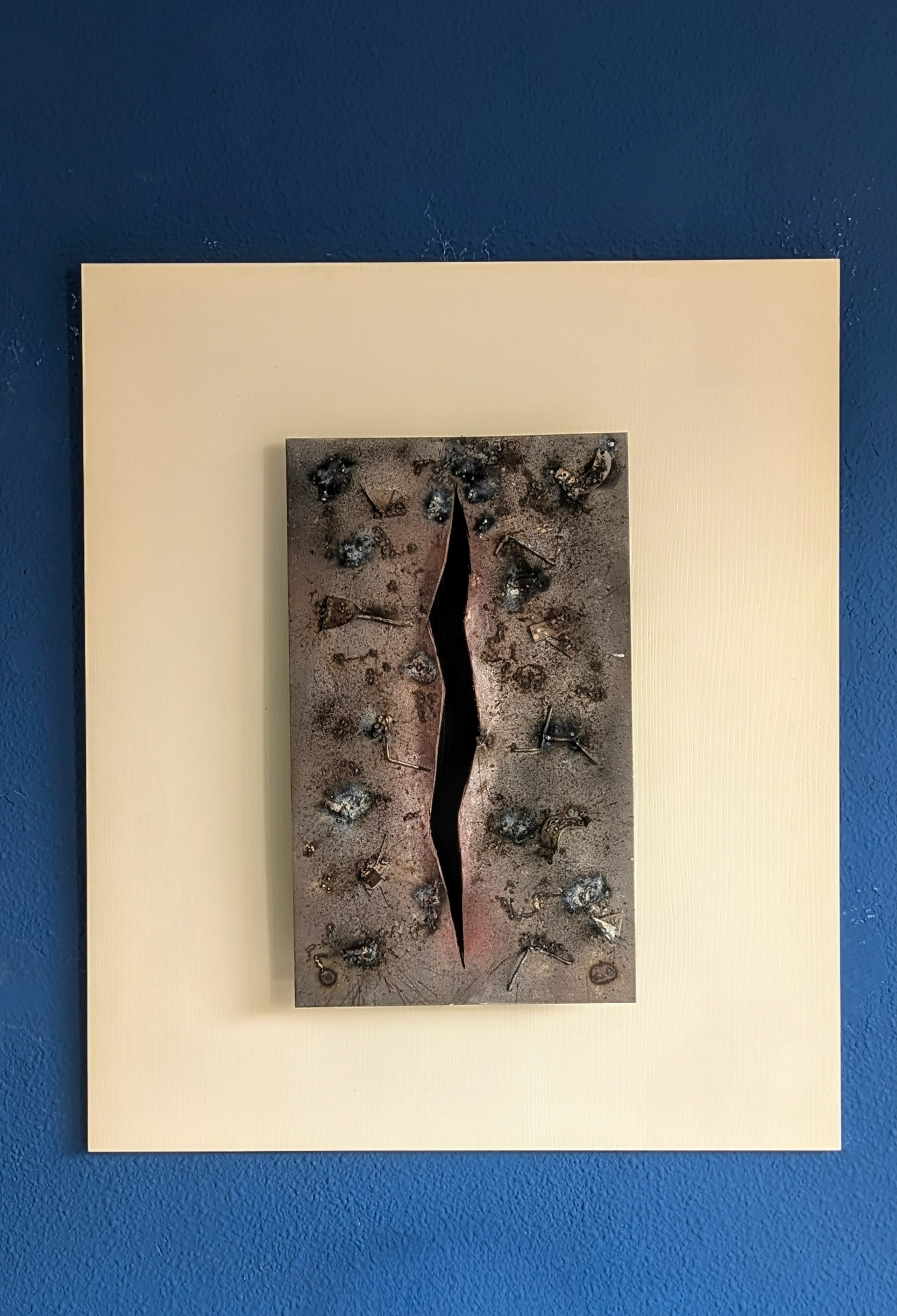 Destrucción · Placa de acero reciclado con imagen satelital transferida mediante oxidación y abrasión · Estructura del Conflicto · Paisajes de Guerra · Luis González Palacios · 2025 · 68×80 cm