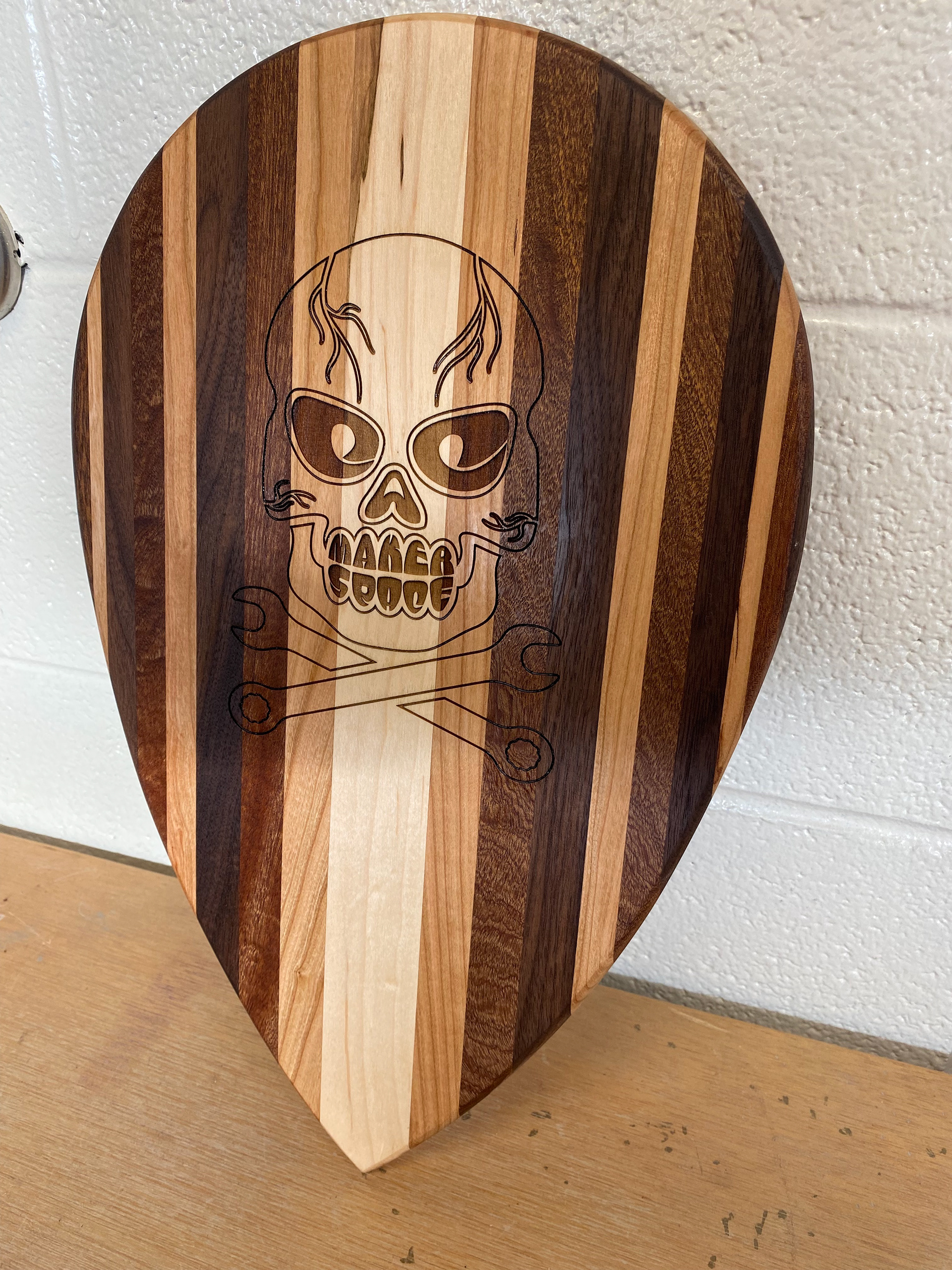 I ended up laser-engraving the design on a guitar pick-shaped cutting board