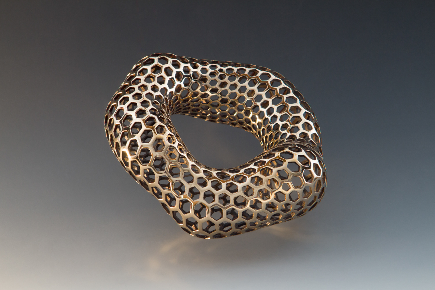 Bracelet 2.3.1.B.1 Print 3, 2023, 3D printed and cast, bronze, patina, 430 grams, 6 x 6 x 2.5 in. (15.25 x 15.25 x  6.25 cm), photographed by Clayton Salley and Professor Kee-ho Yuen
