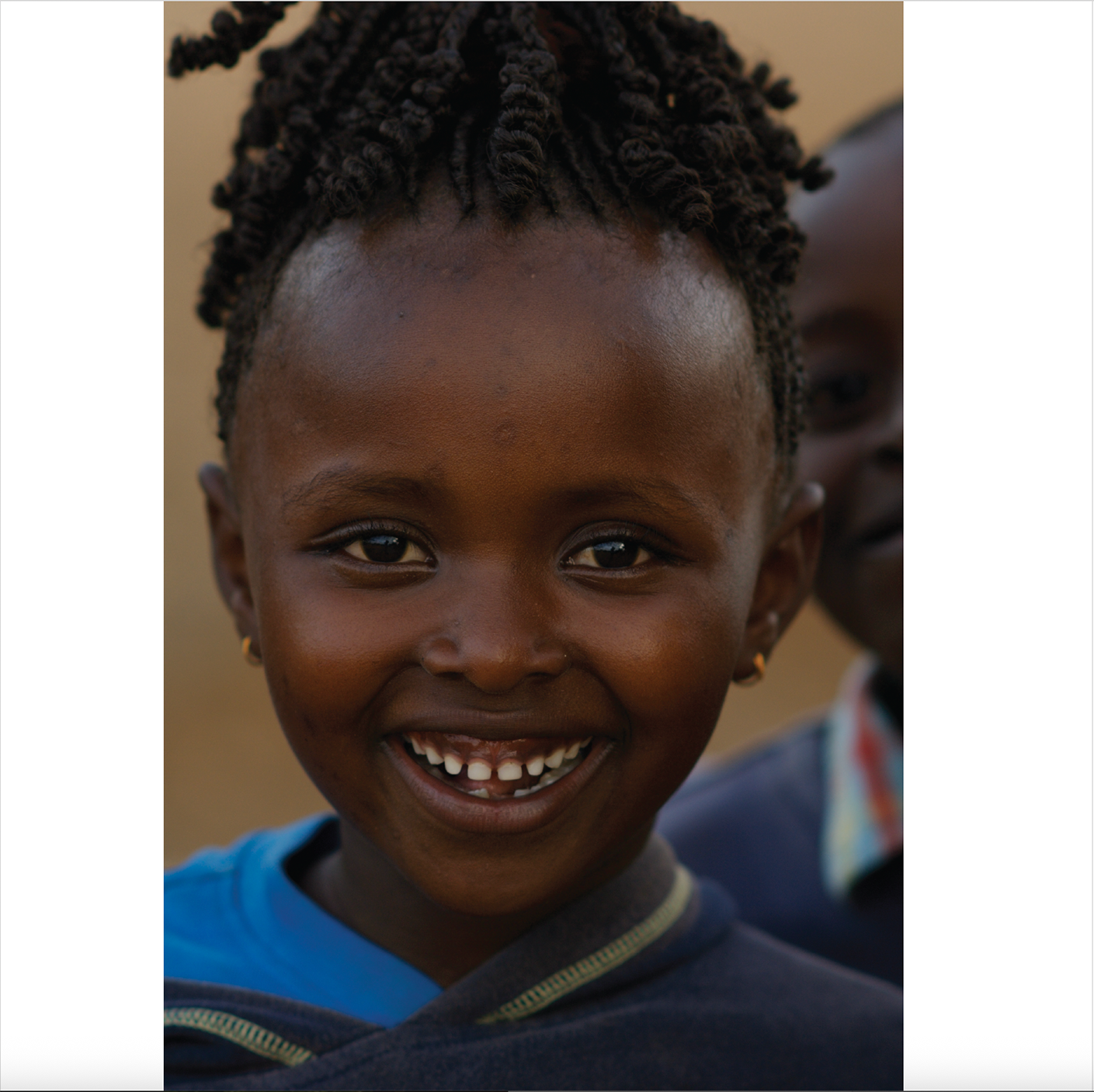 Portrait of a smiling young girl, East Africa, Through Maasailand.