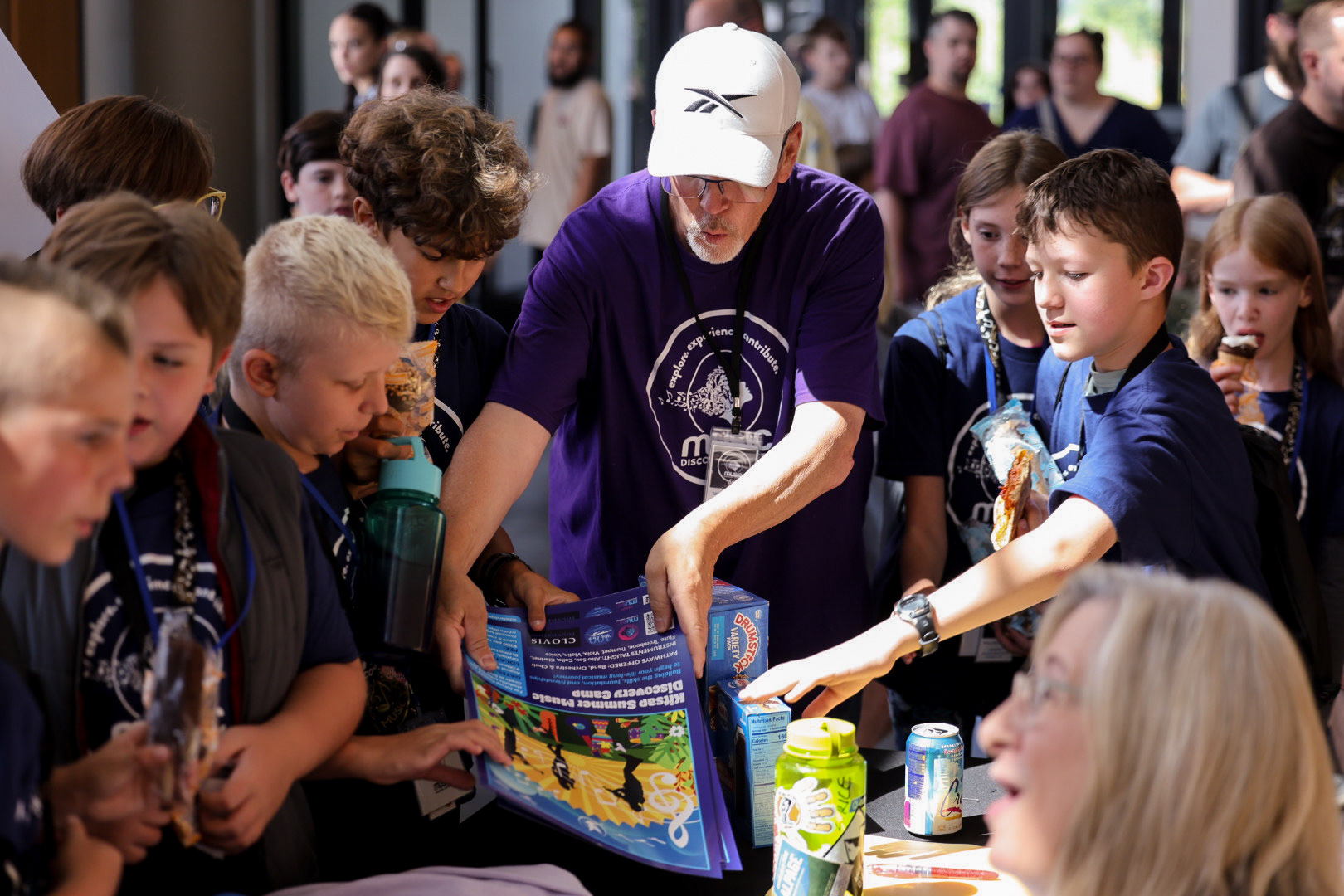 MDC campers looking at the poster